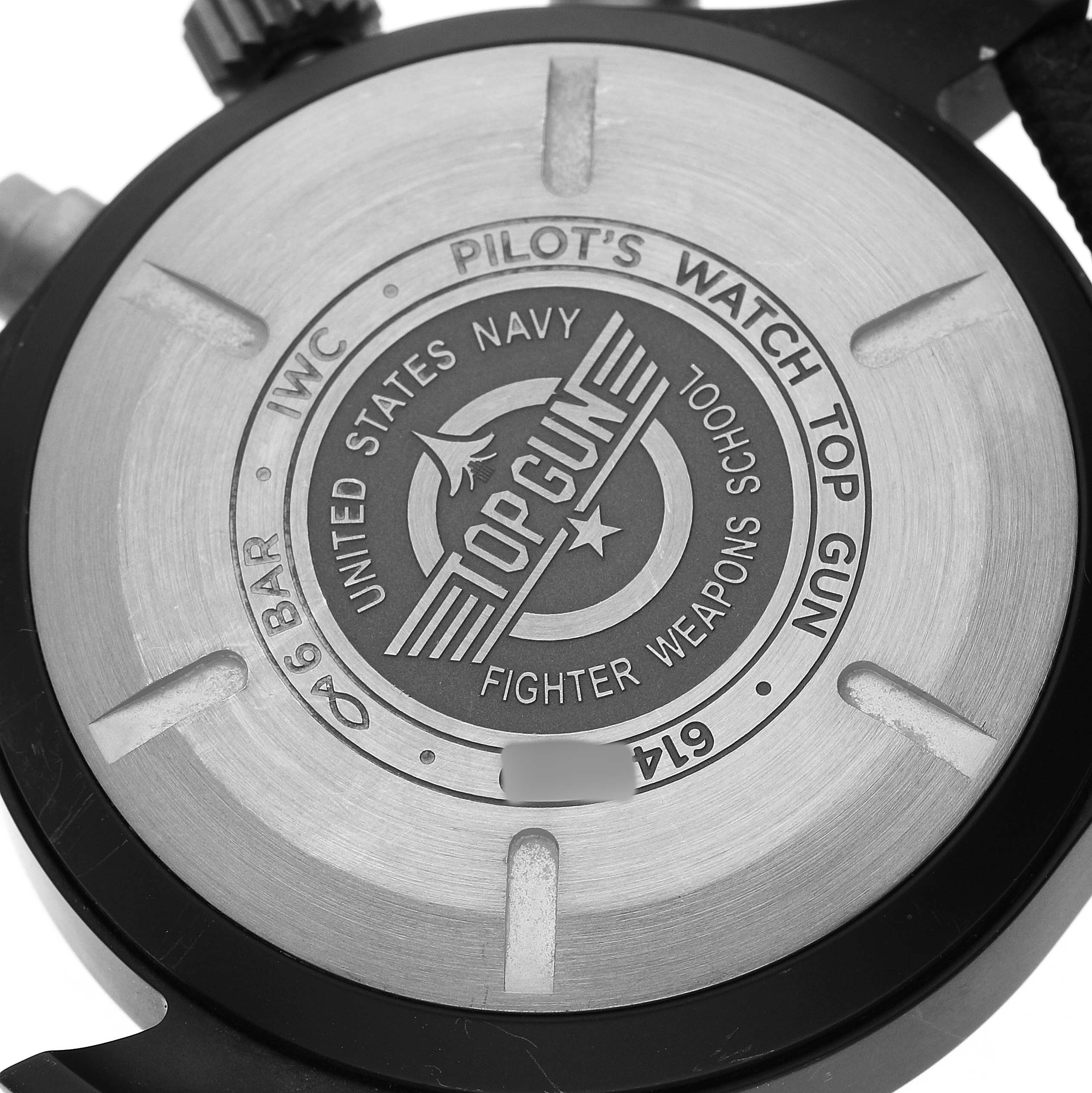 The image shows the back case of the IWC Pilot IW389001 Men's Ceramic Black Dial's Watch Top Gun, featuring engravings and branding details.
