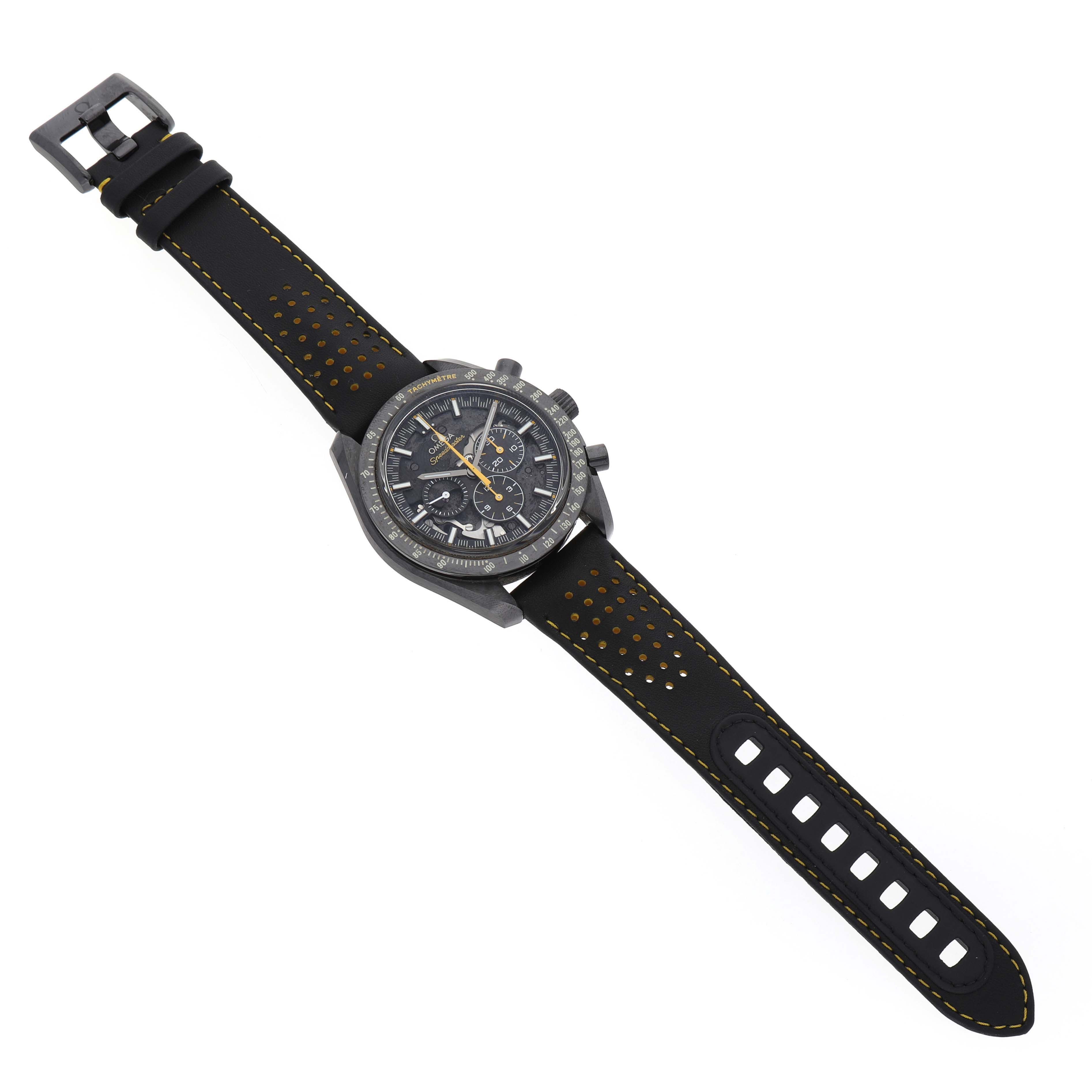 The Omega Speedmaster 311.92.44.30.01.001 Men's Ceramic Black Dial watch is shown from a top-down angle, highlighting its face and perforated strap with yellow stitching.