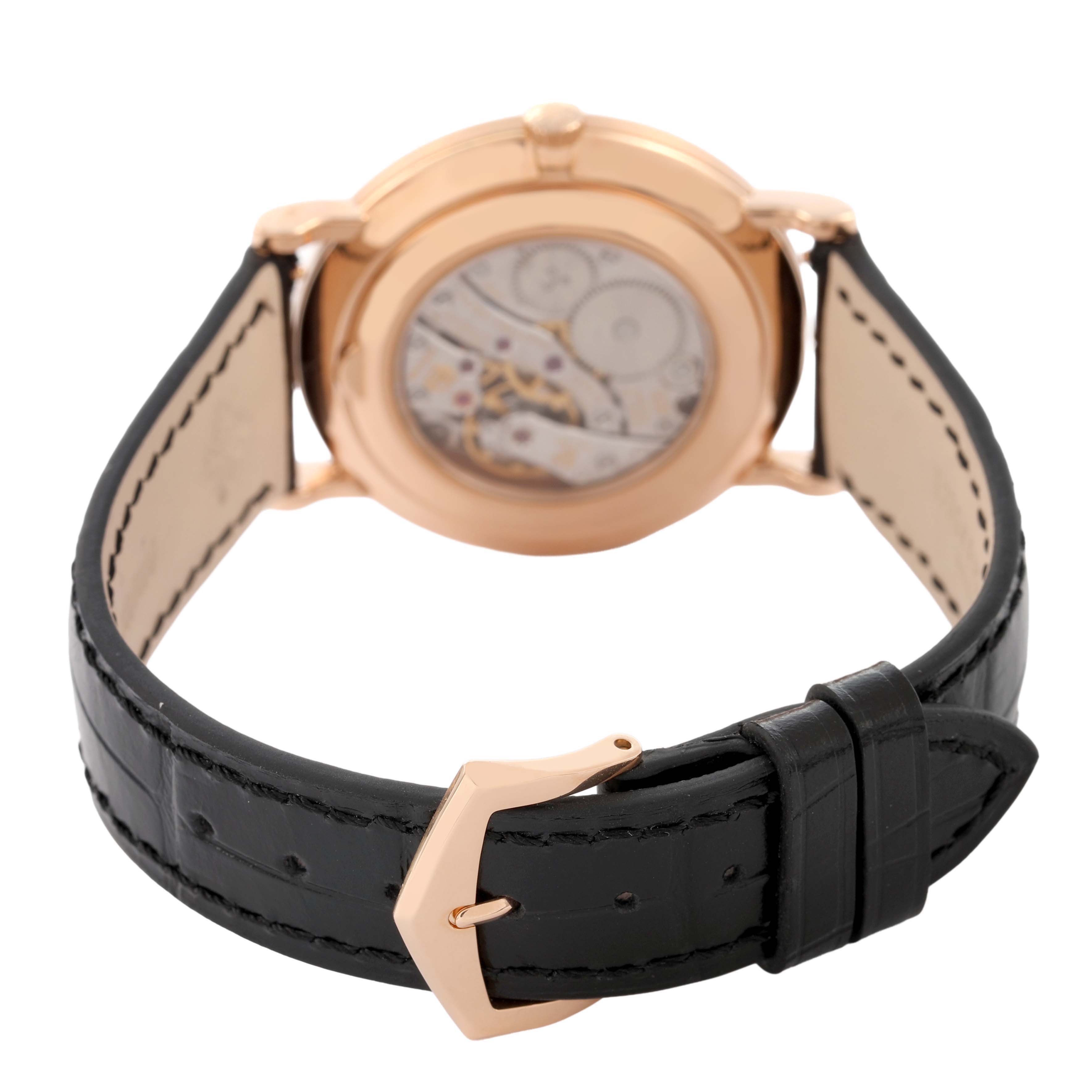 The image shows a Patek Philippe Calatrava 5119R Men's Rose Gold White Dial watch from a rear angle, highlighting the movement and leather strap with buckle.
