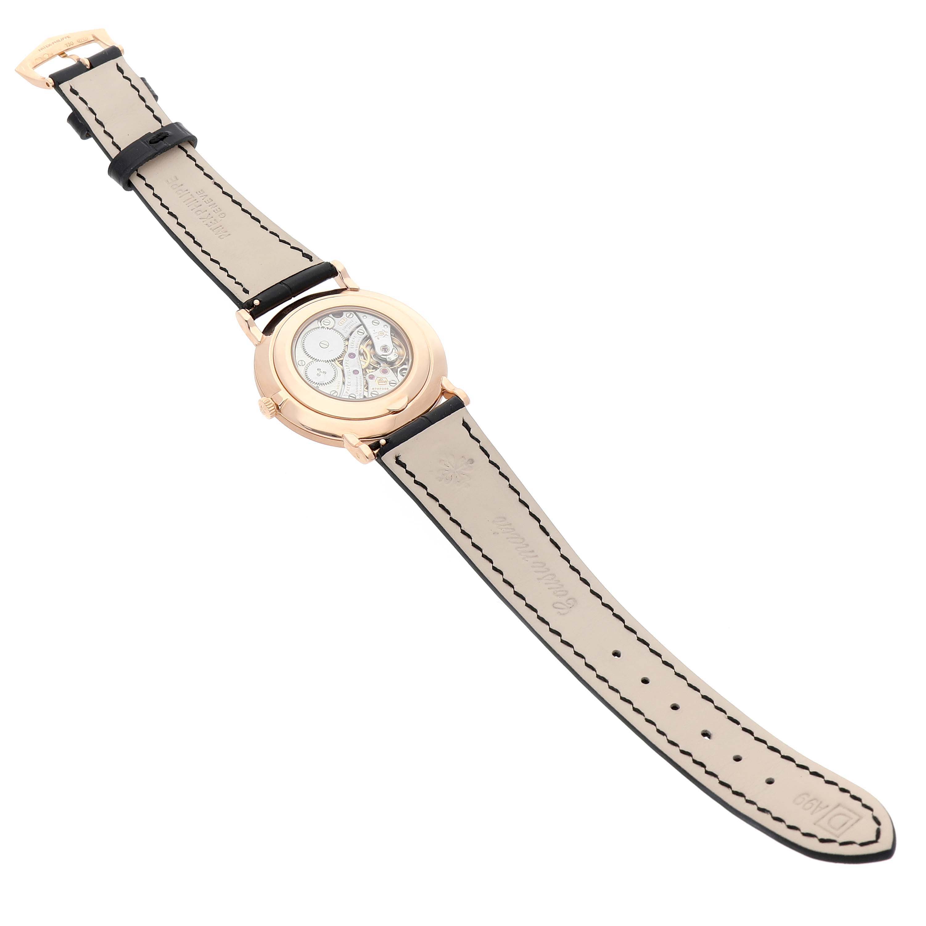 The image shows the back view of a Patek Philippe Calatrava 5119R Men's Rose Gold White Dial watch, highlighting its transparent case back and leather strap.