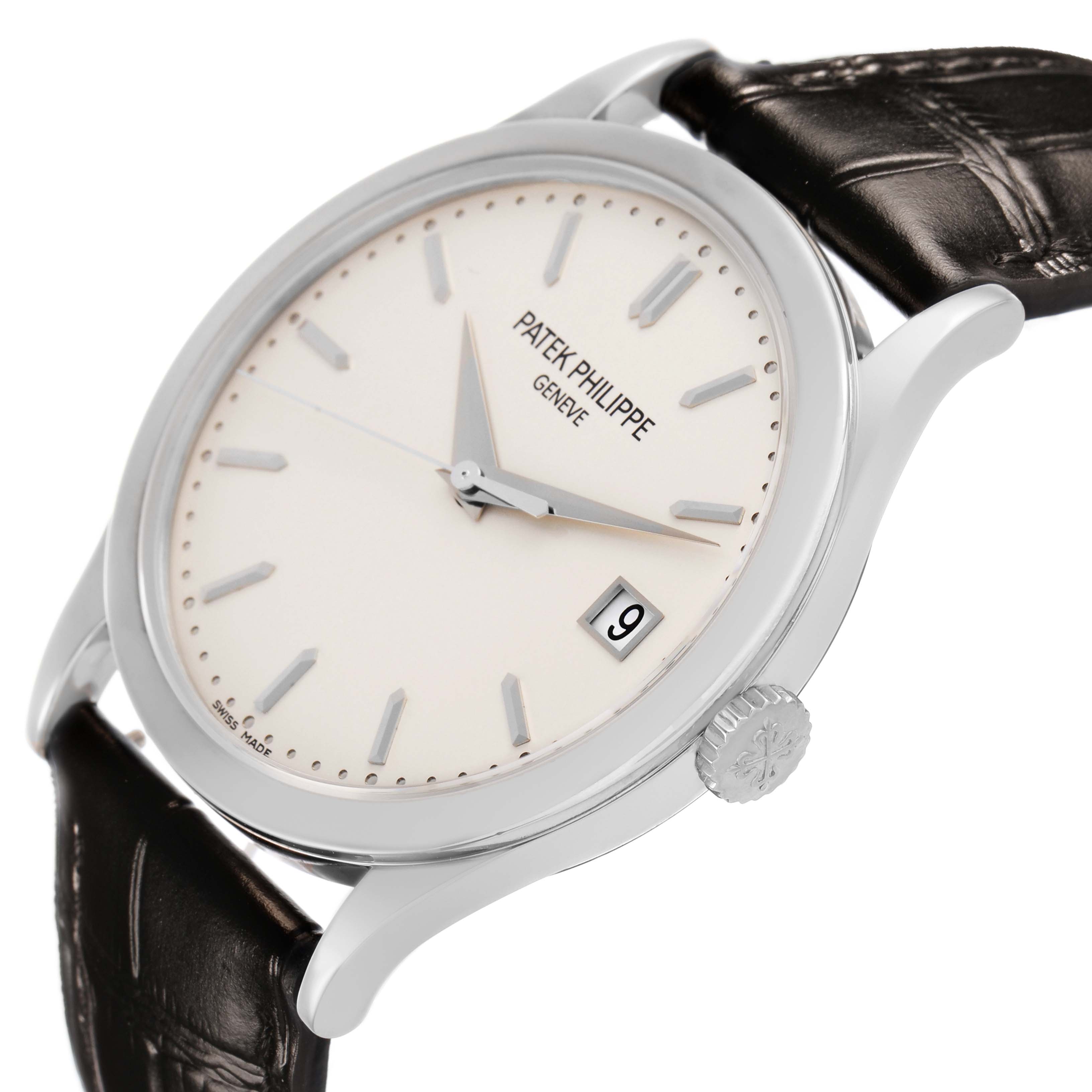 The Patek Philippe Calatrava 5296G Men's White Gold Silver Dial watch is shown at a three-quarter angle, highlighting the face, crown, date window, and leather strap.