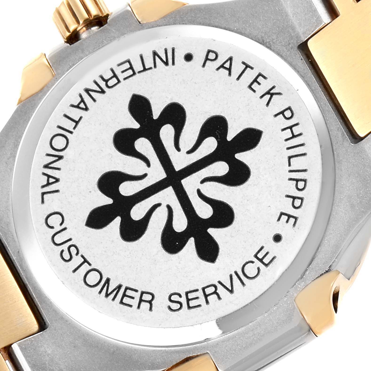 The image shows the case back of a Patek Philippe Nautilus 4700 Women's Steel and Gold (two tone) White Dial 4700 Women's Steel and Gold (two tone) White Dial watch, including the logo and part of the bracelet.