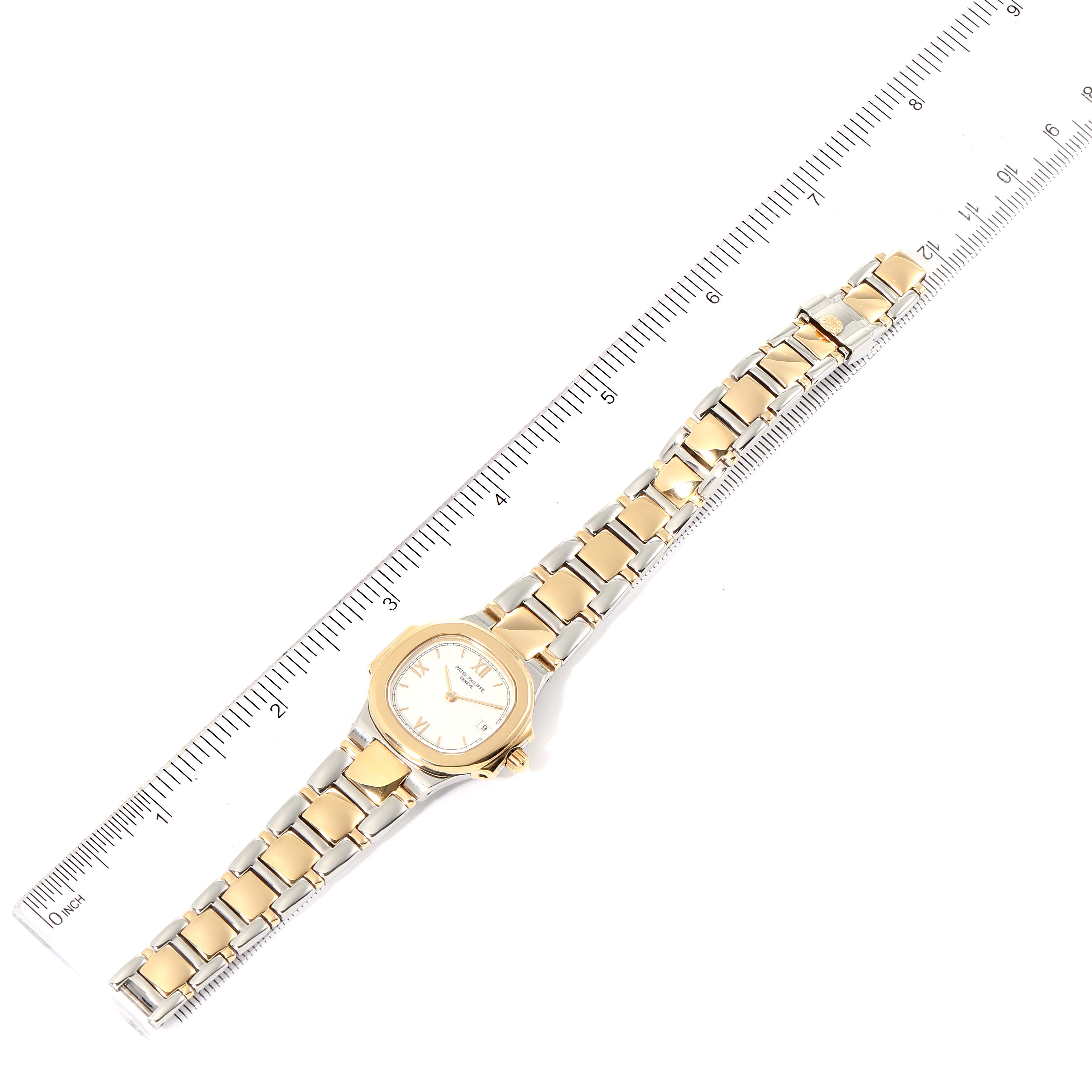 The image displays the Patek Philippe Nautilus 4700 Women's Steel and Gold (two tone) White Dial 4700 Women's Steel and Gold (two tone) White Dial watch laid flat from a top-down angle with a ruler placed alongside for scale.