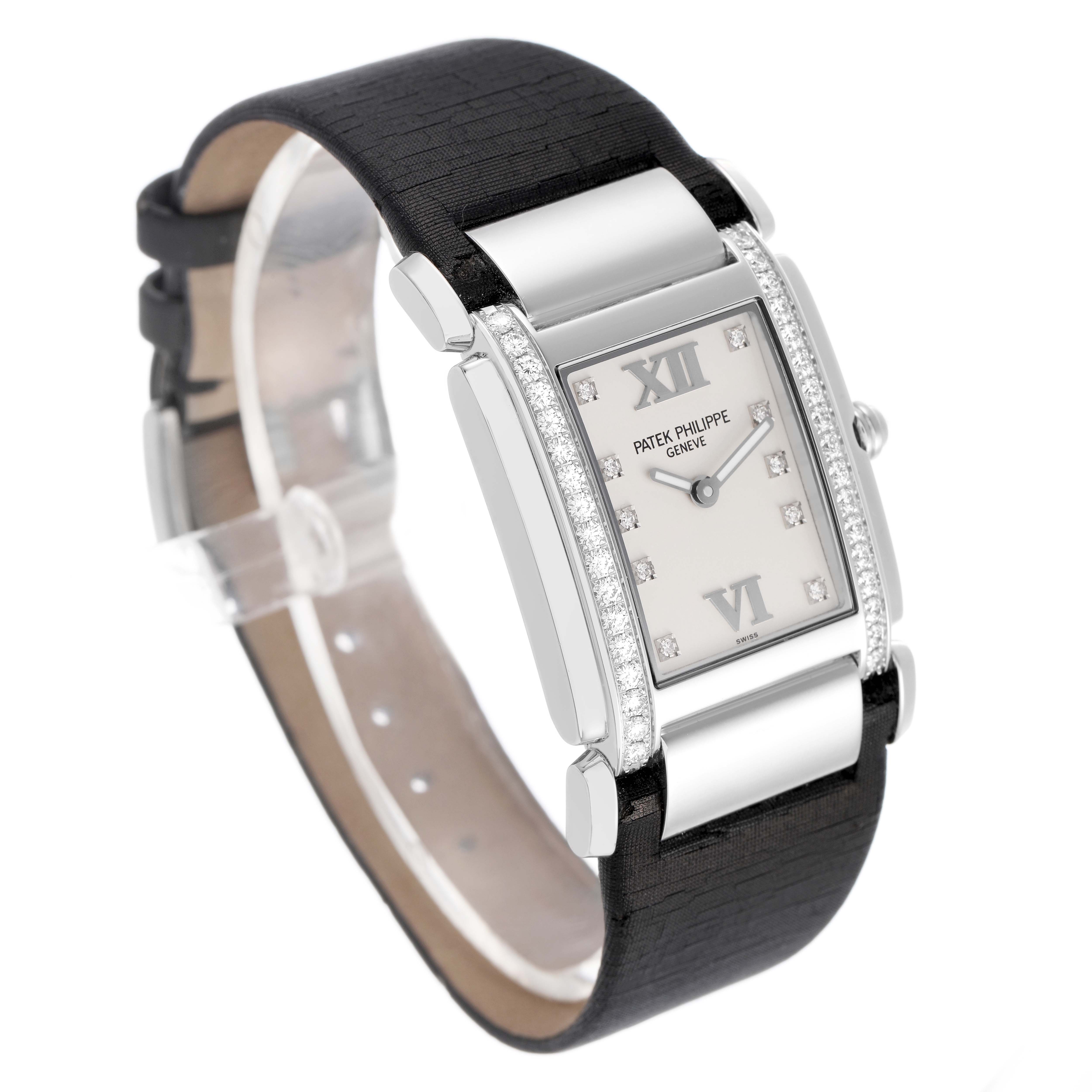 The Patek Philippe Twenty-4 4920G Women's White Gold Silver Dial watch is shown at a three-quarter angle, highlighting its rectangular face, diamond bezel, and black strap.