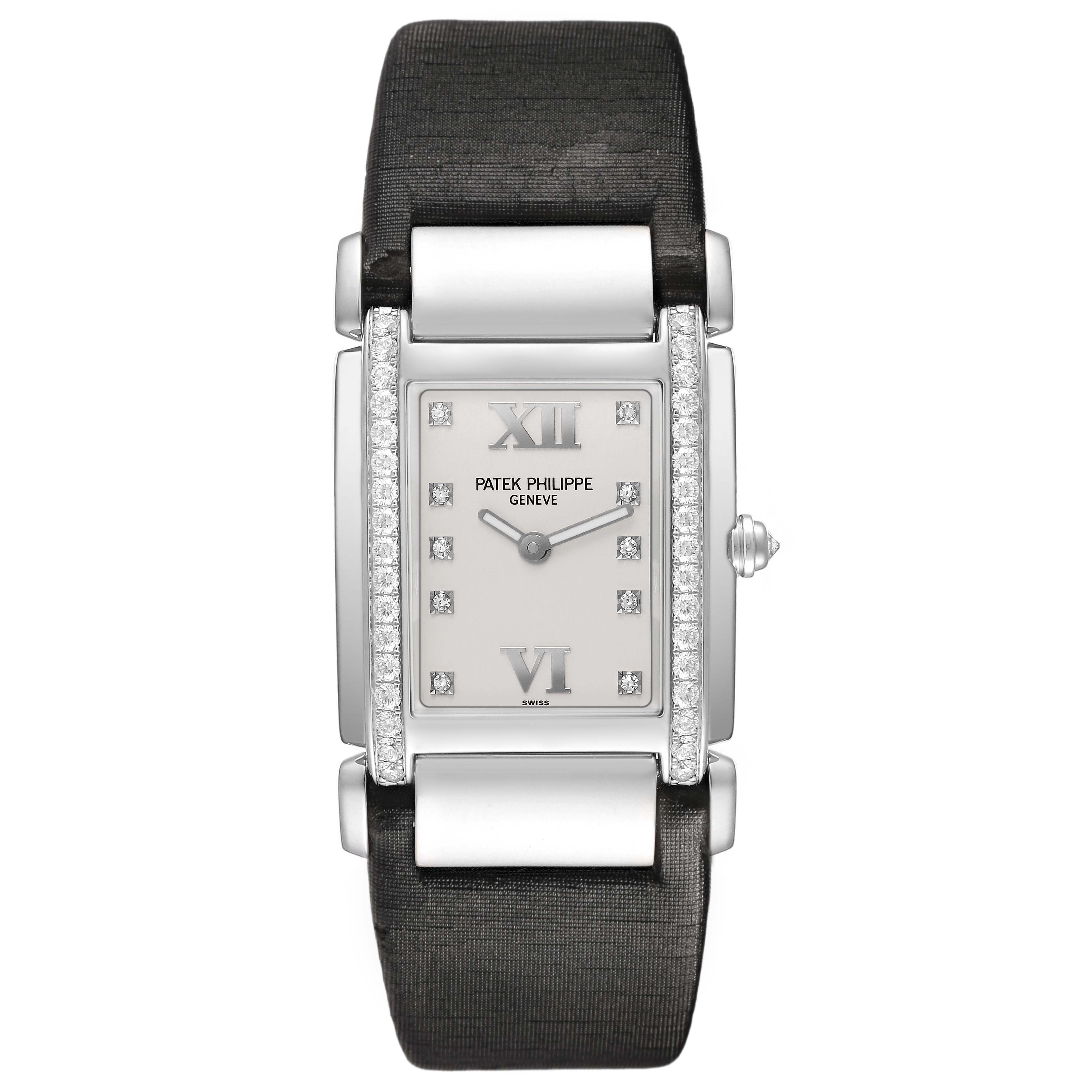 The Patek Philippe Twenty-4 4920G Women's White Gold Silver Dial watch is shown from a front angle, highlighting its rectangular face, diamond accents, and fabric strap.