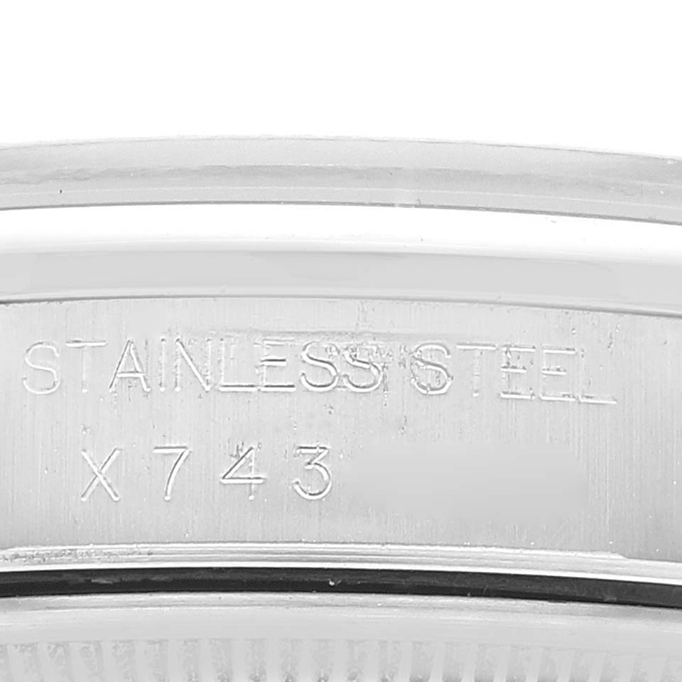 The image shows an engraved close-up of the case back of a Rolex Air-King 14000 Men's Stainless Steel Pink Dial 14000 Men's Stainless Steel Pink Dial watch, displaying "STAINLESS STEEL" and a serial number.