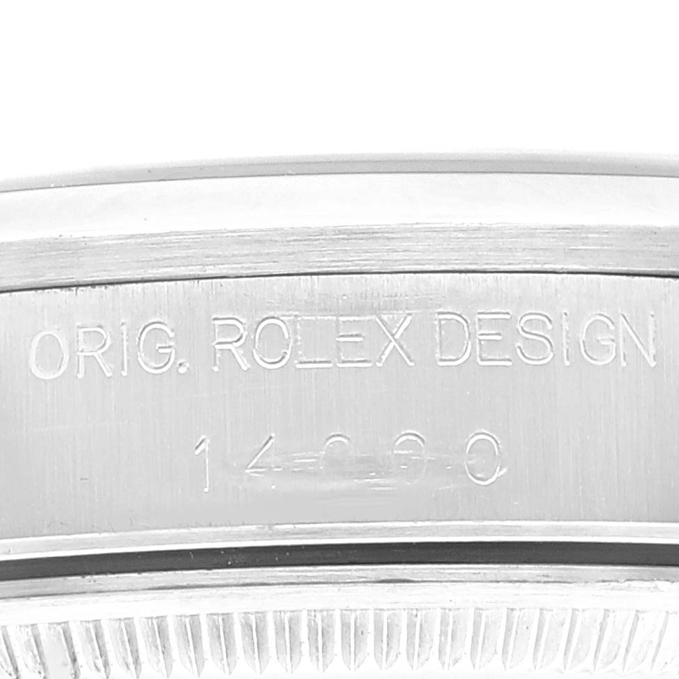 The image shows a close-up of the side of a Rolex Air-King 14000 Men's Stainless Steel Black Dial 14000 Men's Stainless Steel Black Dial watch, featuring engravings of the model number and "ORIG. ROLEX DESIGN."