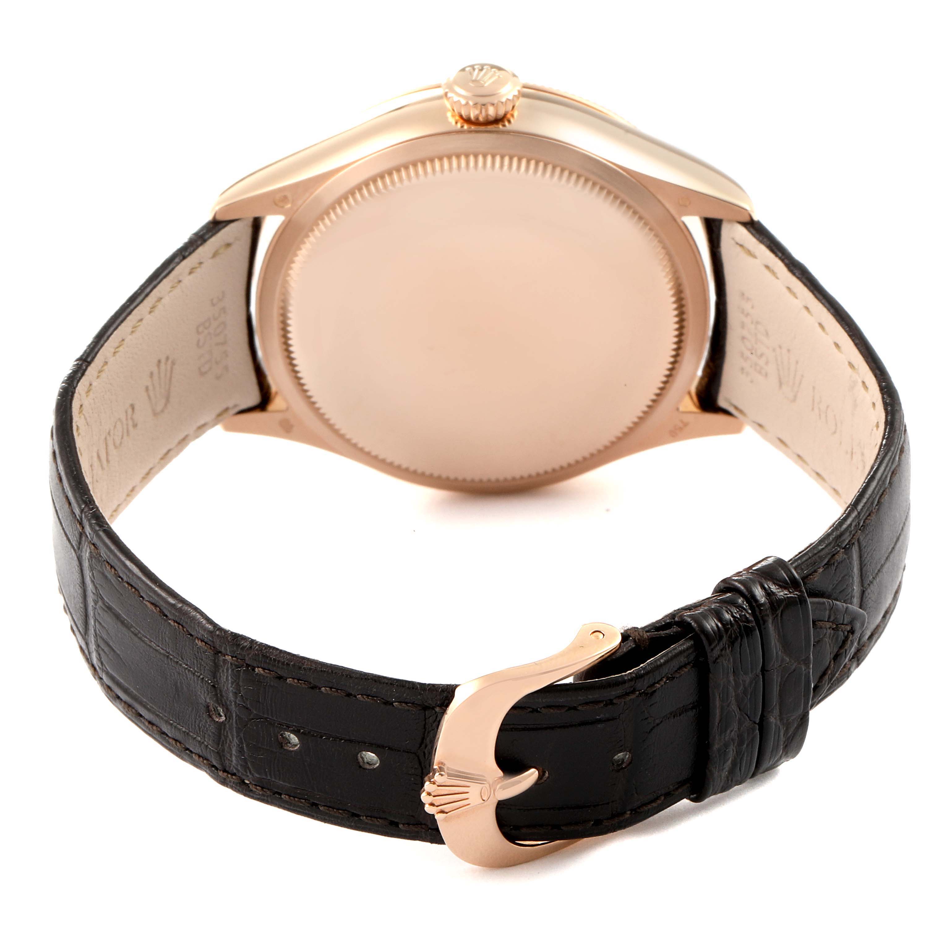 The image shows the back of a Rolex Cellini 50525 Men
s Rose Gold Brown Dial 50525 Men
s Rose Gold Brown Dial watch, highlighting its case back, crown, and leather strap with a clasp.