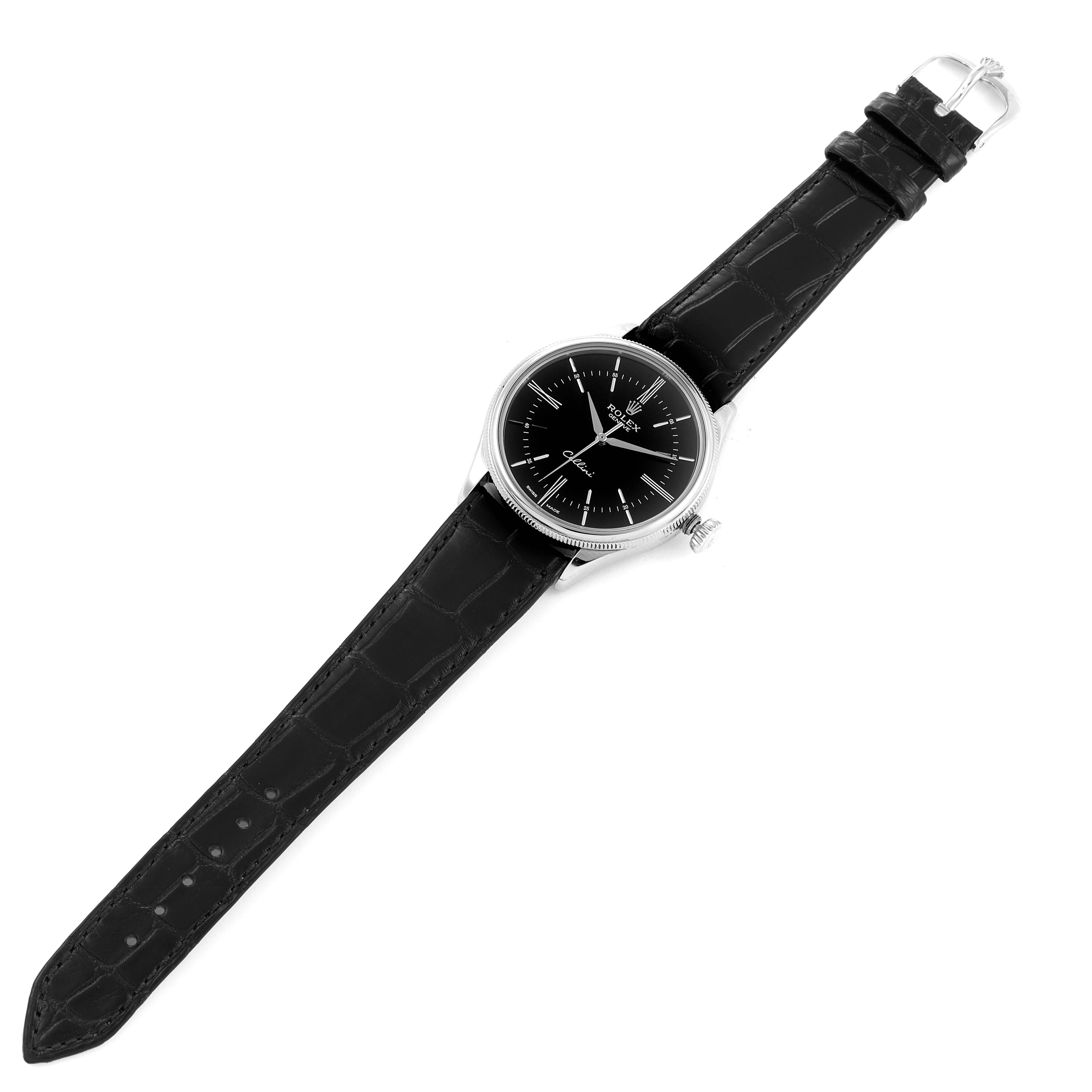 The image shows a top-down view of a Rolex Cellini 50509 Men's White Gold Black Dial 50509 Men's White Gold Black Dial watch, featuring its black dial, silver case, and black leather strap.