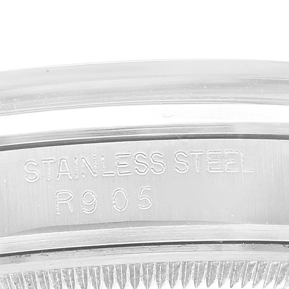 The image shows a close-up of the bezel and engraved edge of a stainless steel Rolex Vintage Collection 15000 Men
s Stainless Steel Silver Dial 15000 Men
s Stainless Steel Silver Dial model watch.