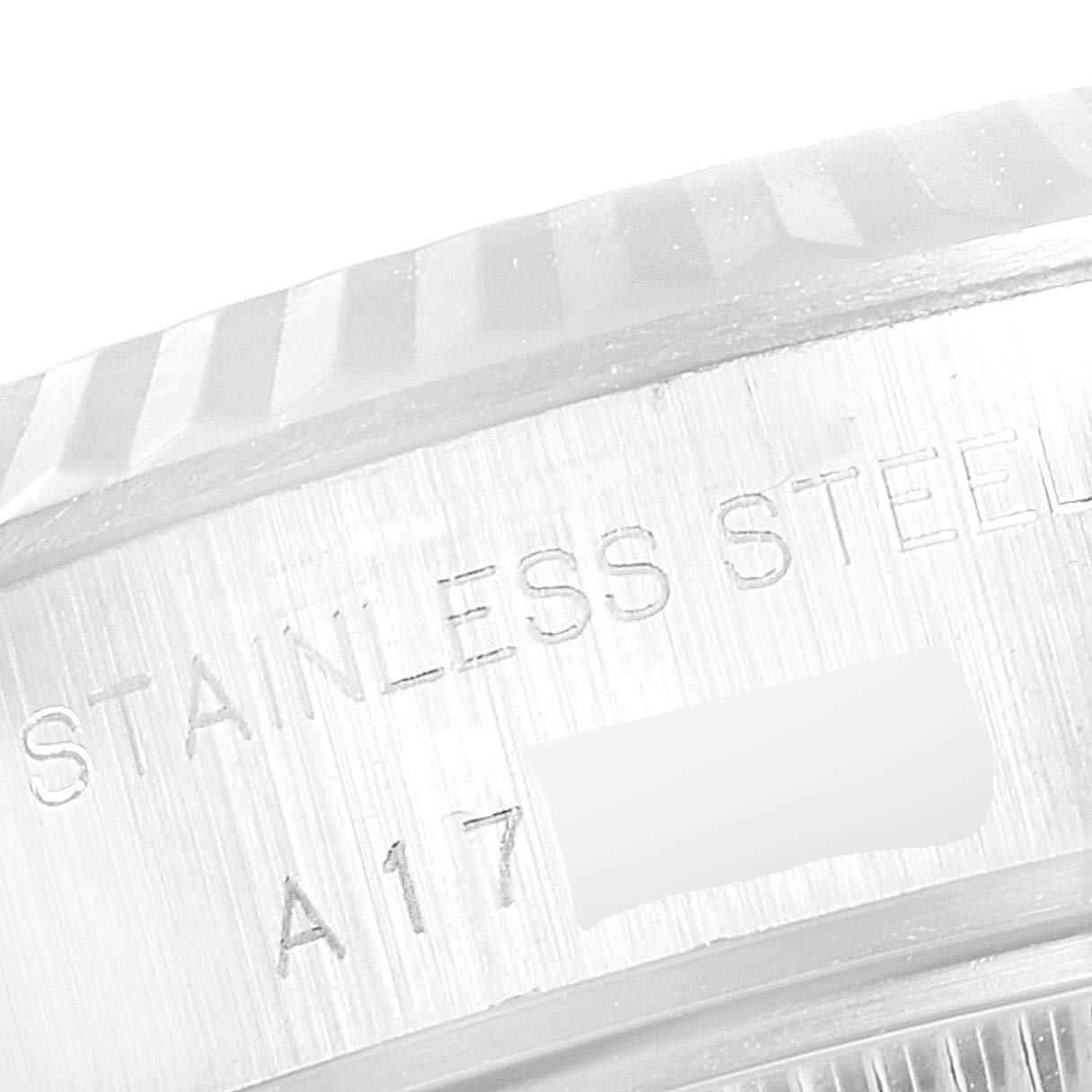 The image shows a close-up view of the stainless steel bezel and serial number of a Rolex Datejust 69174 Women's Stainless Steel Pink Dial 69174 Women's Stainless Steel Pink Dial watch.