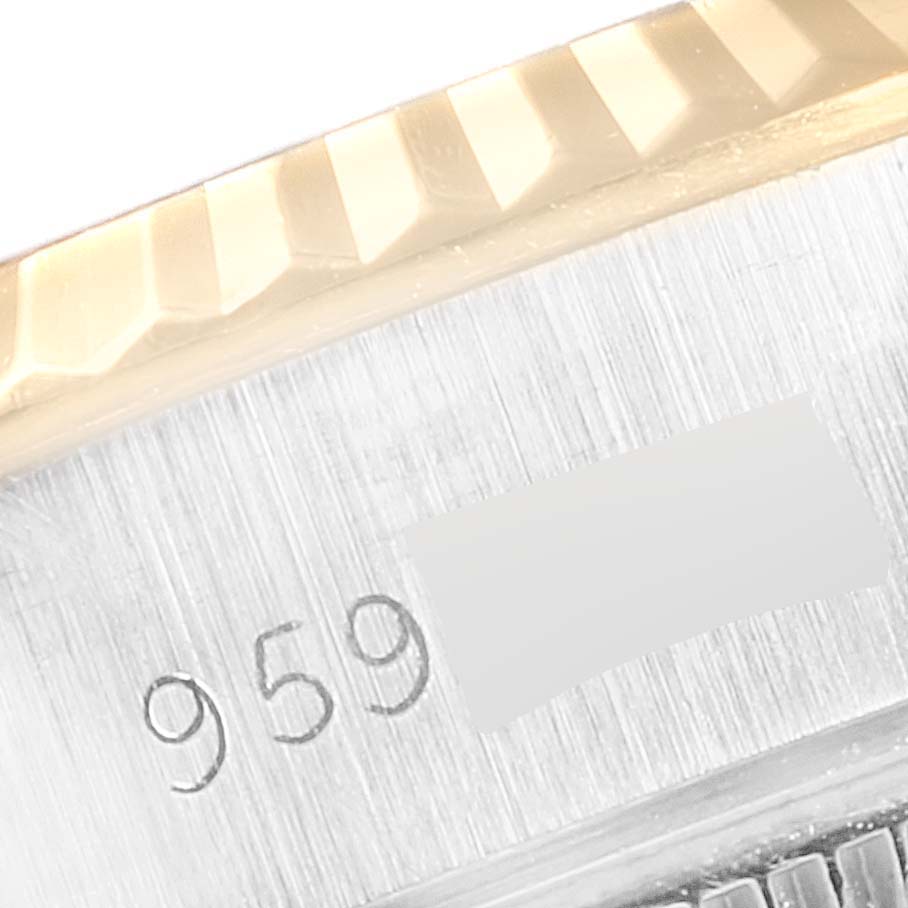 This close-up image shows a partial view of the bezel and engraved serial number on a Rolex Datejust 69173 Women
s Steel and Gold (two tone) Champagne Dial 69173 Women
s Steel and Gold (two tone) Champagne Dial watch.