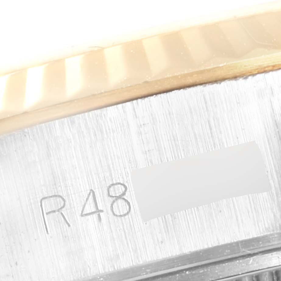 This image shows a close-up view of the bezel and engraving on the case of a Rolex Datejust 69173 Women
s Steel and Gold (two tone) Champagne Dial 69173 Women
s Steel and Gold (two tone) Champagne Dial watch.