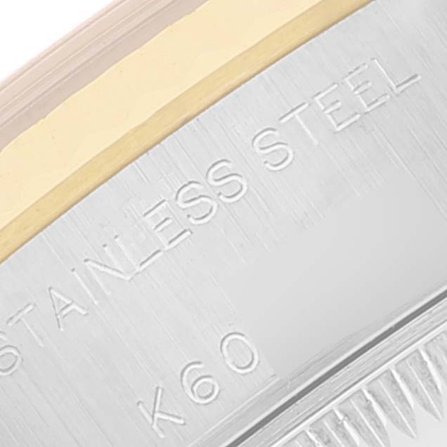 This close-up shows the side of the Rolex Datejust 79173 Women's Steel and Gold (two tone) Grey Dial 79173 Women's Steel and Gold (two tone) Grey Dial watch case, displaying the "Stainless Steel" engraving.