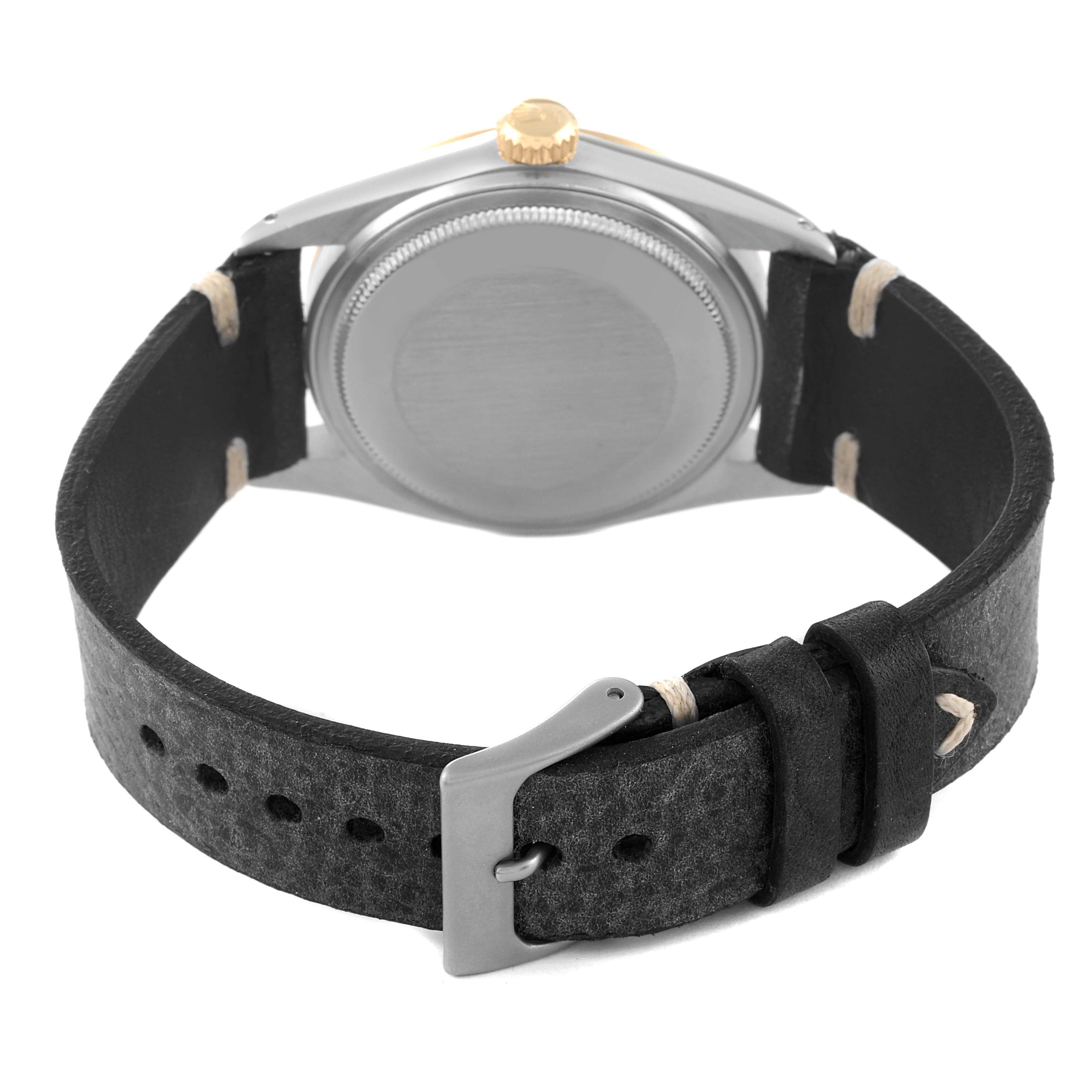 The image shows the back view of a Vintage Collection Rolex watch with a black leather strap and a silver buckle.