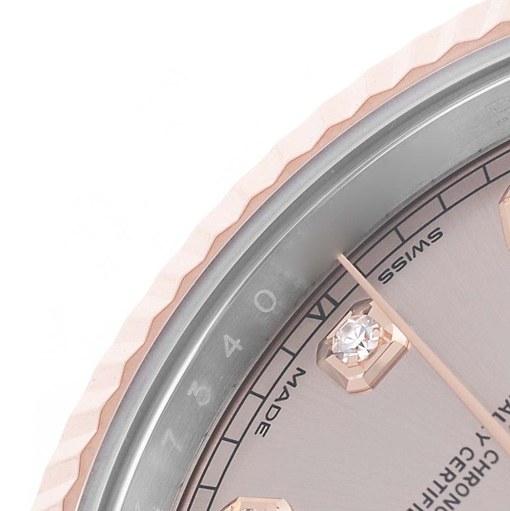 The image shows a close-up of the Rolex Datejust 41 126331 Men's Steel and Gold (two tone) Pink Dial, highlighting the bezel, part of the dial, and diamond hour markers.