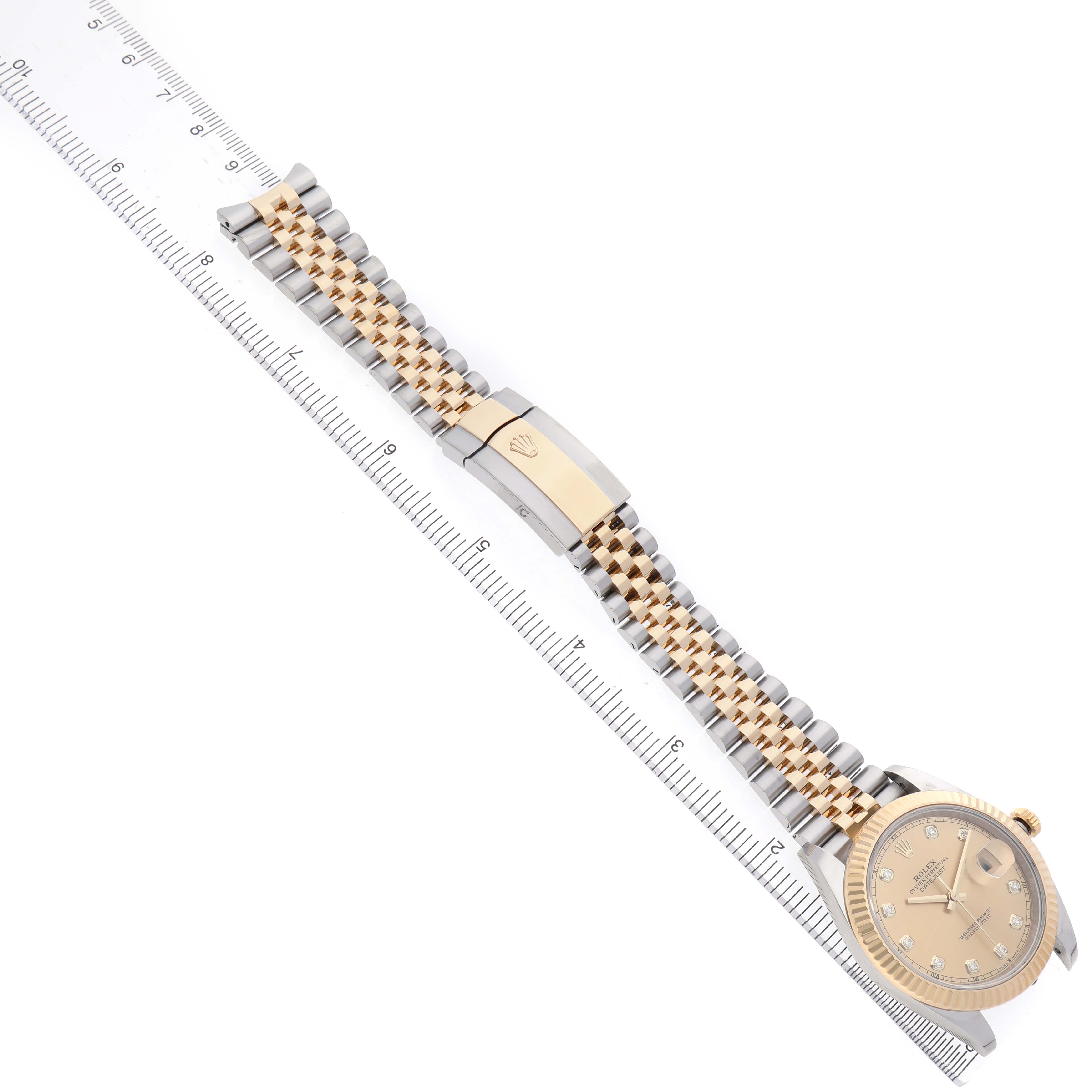 The Rolex Datejust 41 12633 Men's Steel and Gold (two tone) Champagne Dial is shown from an overhead angle, displaying the full bracelet, clasp, dial, and ruler for scale.