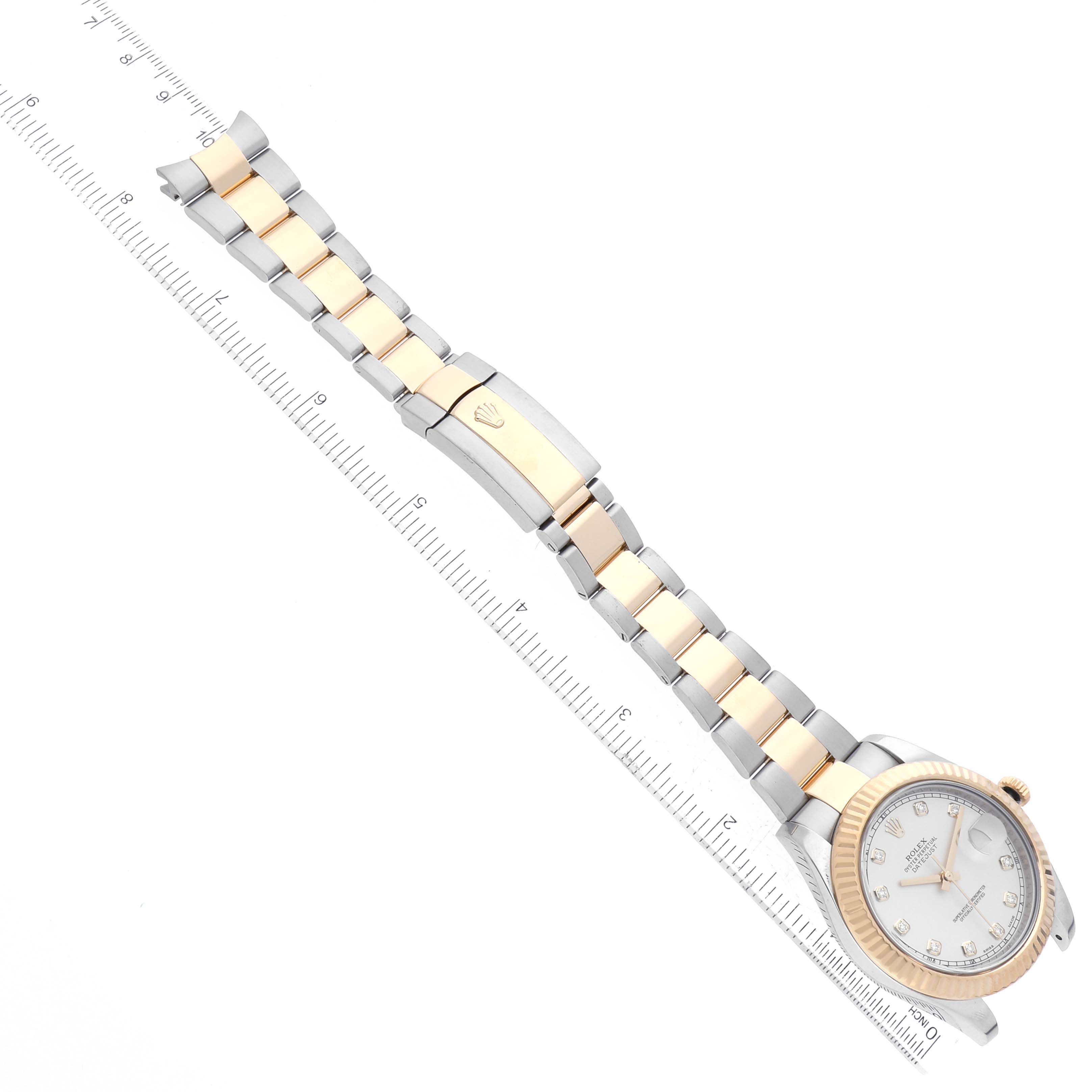 The Rolex Datejust 41 116333 Men's Steel and Gold (two tone) Silver Dial 116333 Men's Steel and Gold (two tone) Silver Dial watch is shown at a diagonal angle, featuring the face, bezel, and two-tone bracelet next to a ruler for scale.