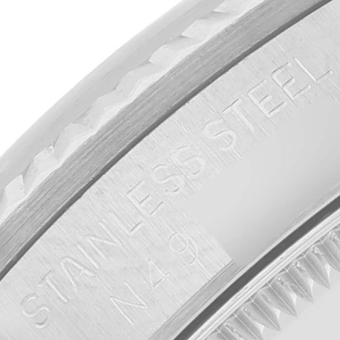 The image shows a close-up of the stainless steel edge and bezel of a Rolex Mid-Size 68274 Women
s Stainless Steel Silver Dial 68274 Women
s Stainless Steel Silver Dial watch.