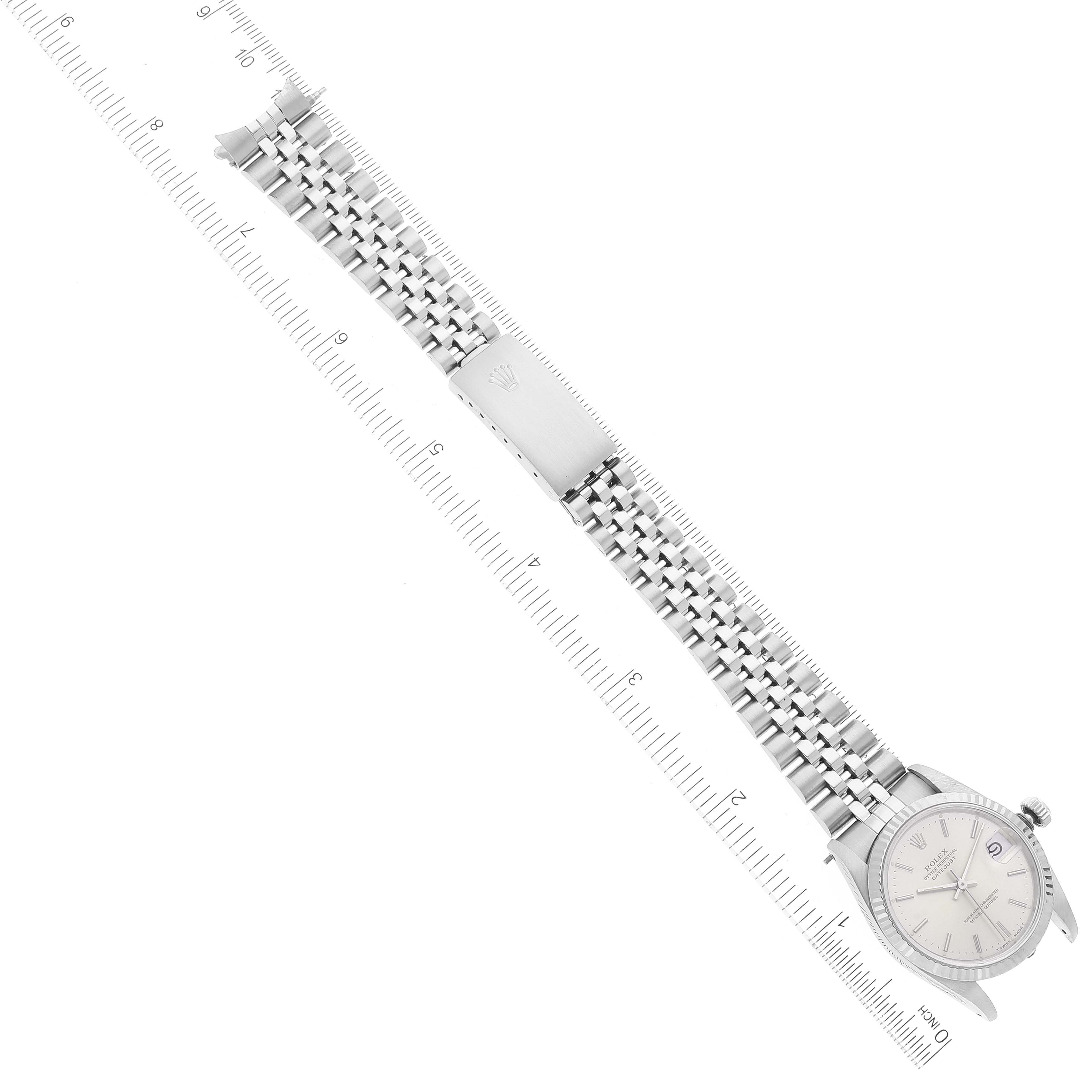 The image shows a top-down view of the Mid-Size Rolex watch with its dial, bracelet, and clasp fully visible.