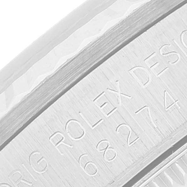 This close-up image shows part of the bezel and the engraved inscriptions on the side of a Rolex Mid-Size 68274 Women
s Stainless Steel Silver Dial 68274 Women
s Stainless Steel Silver Dial watch case.