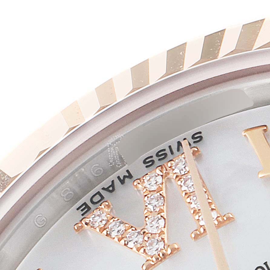 This close-up angle of the Mid-Size Rolex watch shows part of the bezel, dial, and a diamond-encrusted numeral.