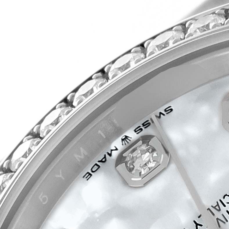 The image shows a close-up of the bezel and dial of a Rolex Mid-Size 278384 Women
s Stainless Steel Mother of Pearl Dial 278384 Women
s Stainless Steel Mother of Pearl Dial model, highlighting the diamond accents and "Swiss Made" marking.
