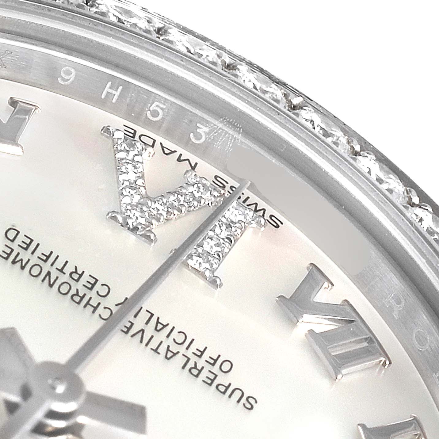 This is a close-up of a Rolex Mid-Size 178384 Women
s Stainless Steel Mother of Pearl Dial 178384 Women
s Stainless Steel Mother of Pearl Dial model watch, showing the dial, hour markers, and a diamond-encrusted bezel.