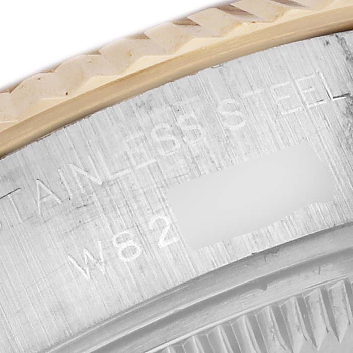 The image shows a close-up of the bezel and case side of a Rolex Datejust 69173 Women's Steel and Gold (two tone) Red Dial 69173 Women's Steel and Gold (two tone) Red Dial watch, highlighting the "STAINLESS STEEL" engraving.