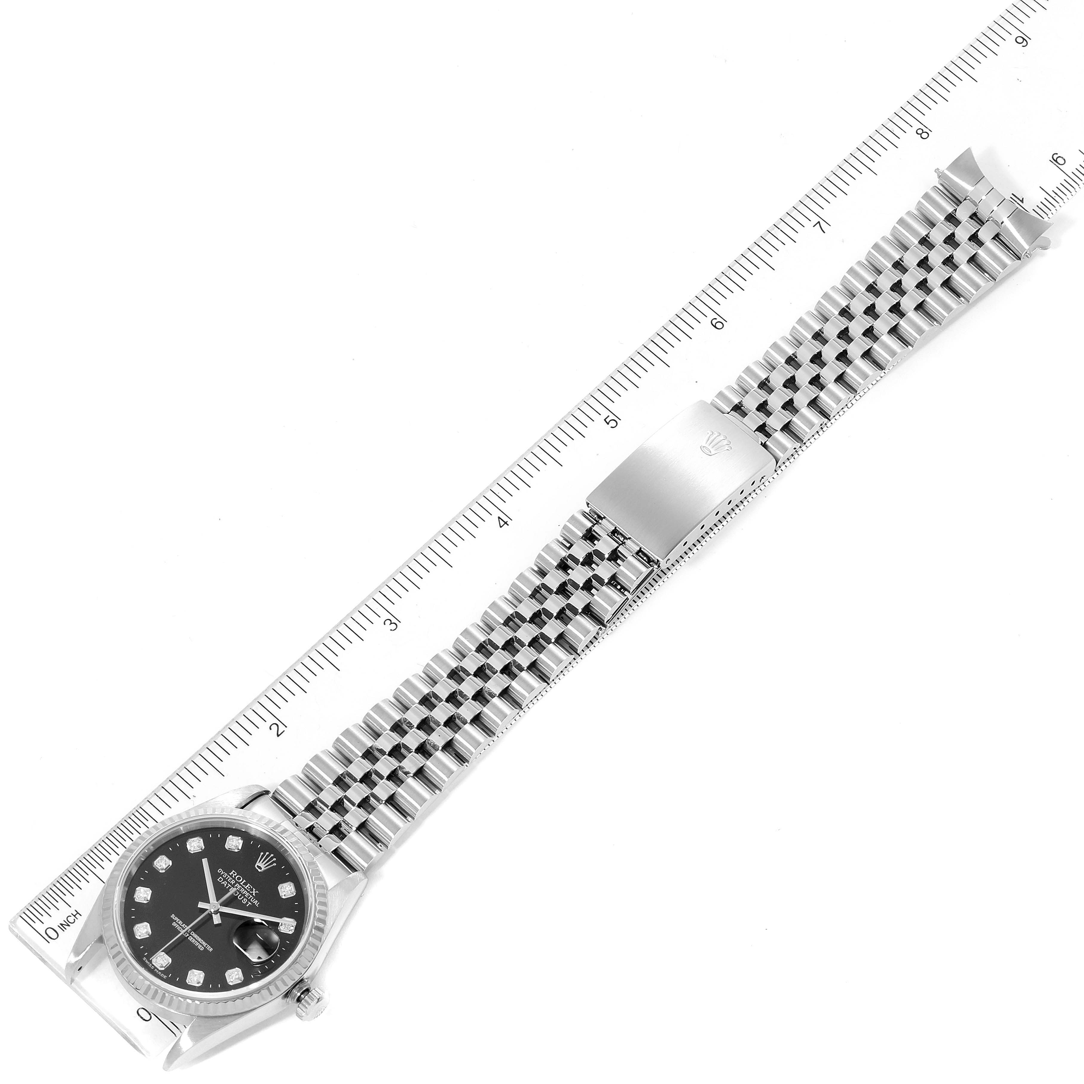 This image shows a top view of a Rolex Datejust 16234 Men
s Stainless Steel Black Dial 16234 Men
s Stainless Steel Black Dial watch, featuring the watch face, bracelet, and clasp positioned alongside a ruler.
