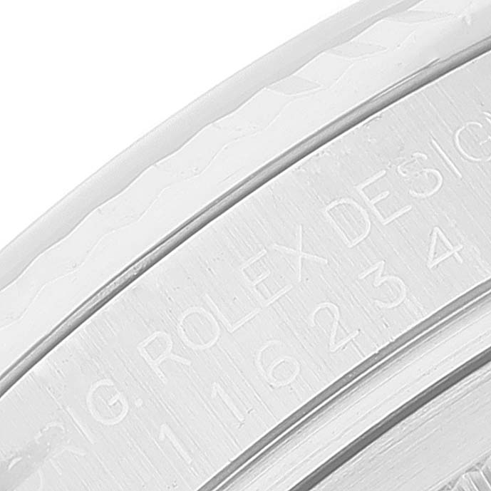 The image shows a close-up of the engraved text on the steel caseback of a Rolex Datejust 116234 Men's Stainless Steel Silver Dial 116234 Men's Stainless Steel Silver Dial.