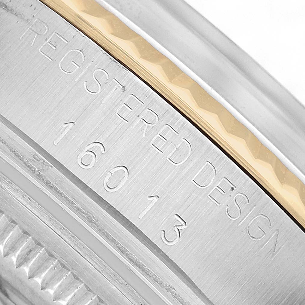 The image shows a close-up of the side of a Rolex Datejust 16013 Men's Steel and Gold (two tone) Champagne Dial, highlighting the model number and registered design engraving.