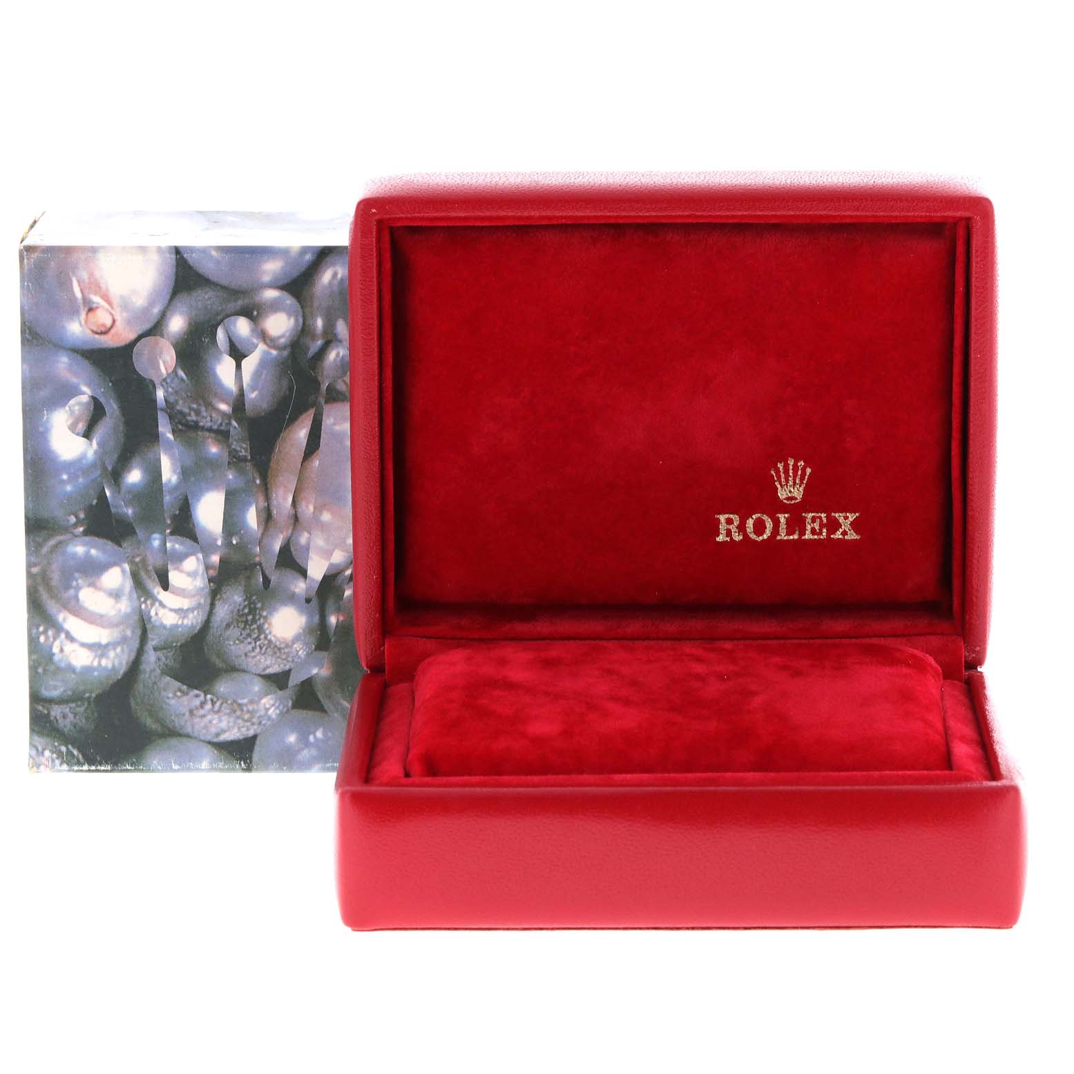 The image shows an open, red Rolex watch box for the Datejust model.