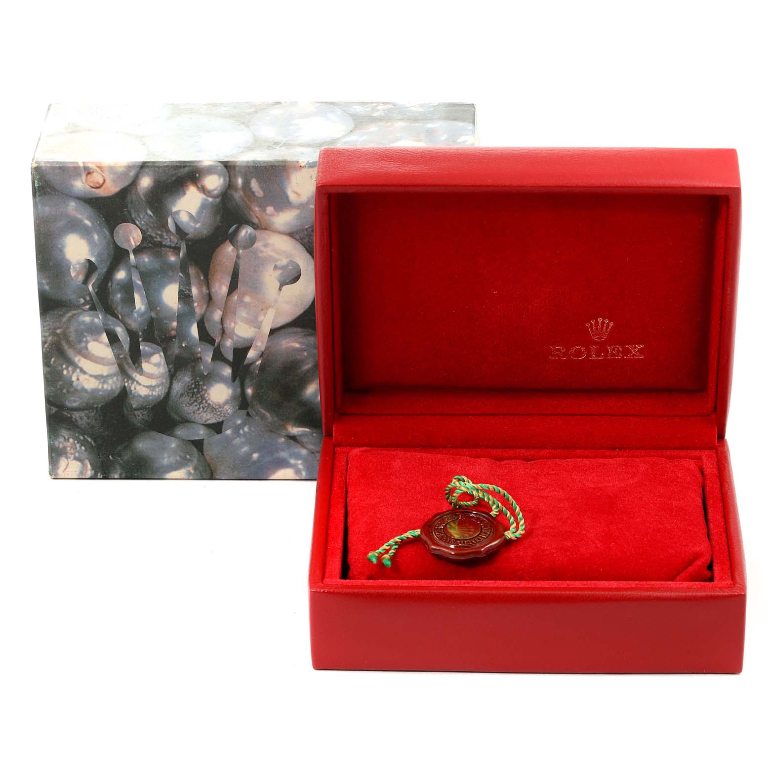 This image shows an empty red Rolex Datejust 79173 Women's Steel and Gold (two tone) Silver Dial 79173 Women's Steel and Gold (two tone) Silver Dial watch box and a tag, with an outer decorative box beside it.