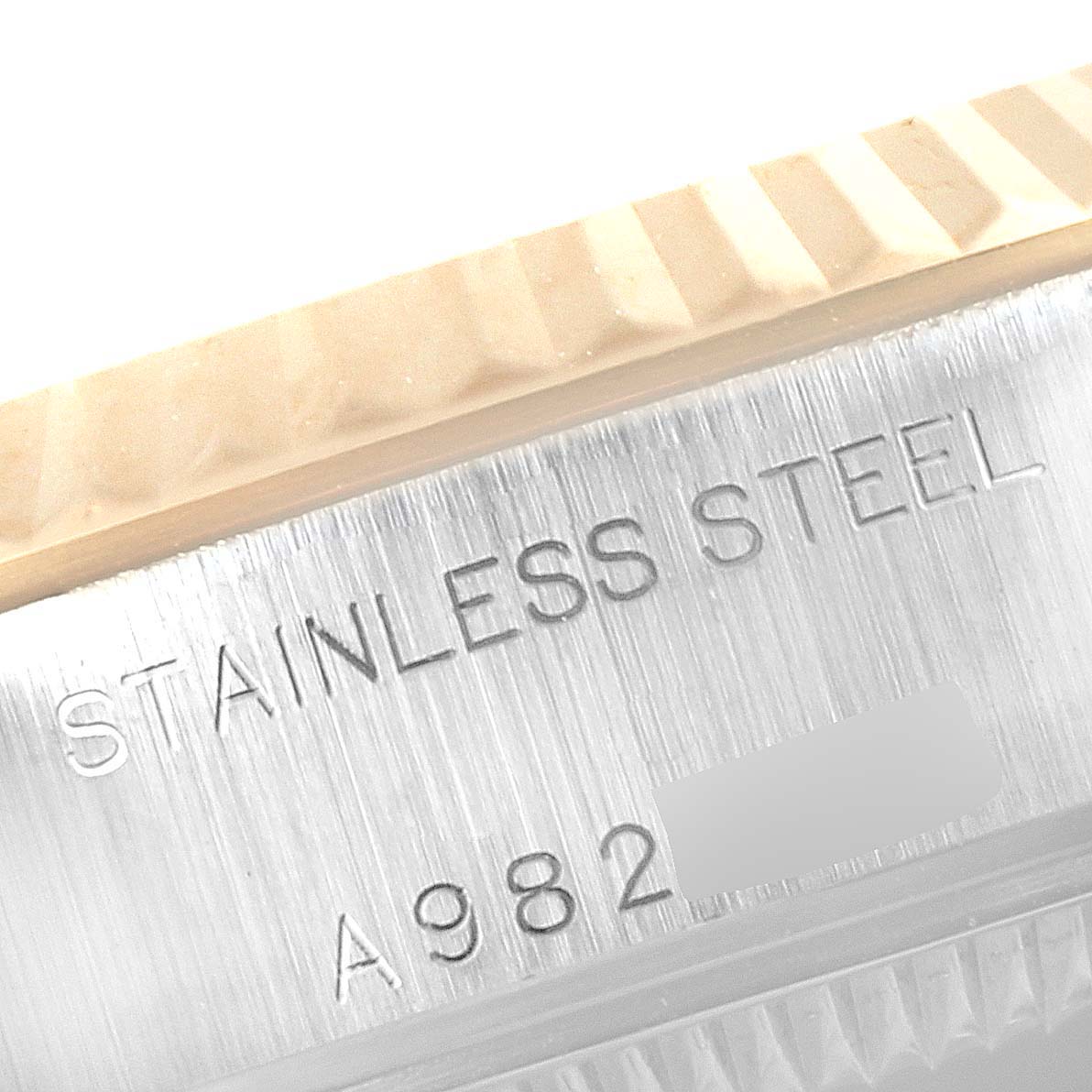 This image shows an angled close-up of the stainless steel side of a Rolex Datejust 79173 Women's Steel and Gold (two tone) Silver Dial 79173 Women's Steel and Gold (two tone) Silver Dial, featuring the model inscription and part of the fluted bezel.