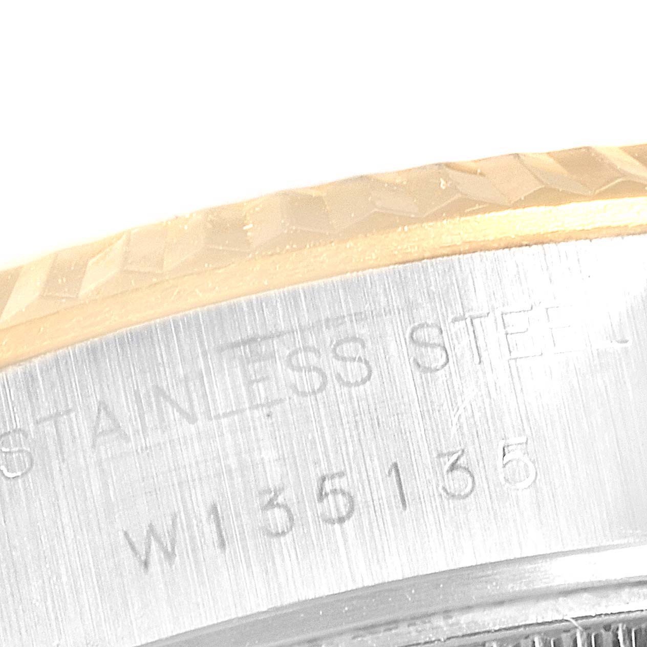 The image shows a close-up of the Stainless Steel bezel and part of the fluted gold edge of the Rolex Datejust 69173 Women
s Steel and Gold (two tone) Champagne Dial 69173 Women
s Steel and Gold (two tone) Champagne Dial watch.