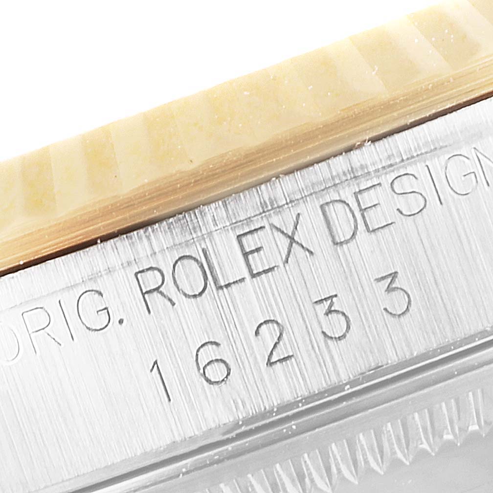 This close-up image shows the engraved case side of a Rolex Datejust 16233 Men's Steel and Gold (two tone) Mother of Pearl Dial 16233 Men's Steel and Gold (two tone) Mother of Pearl Dial, focusing on the model number 16233.