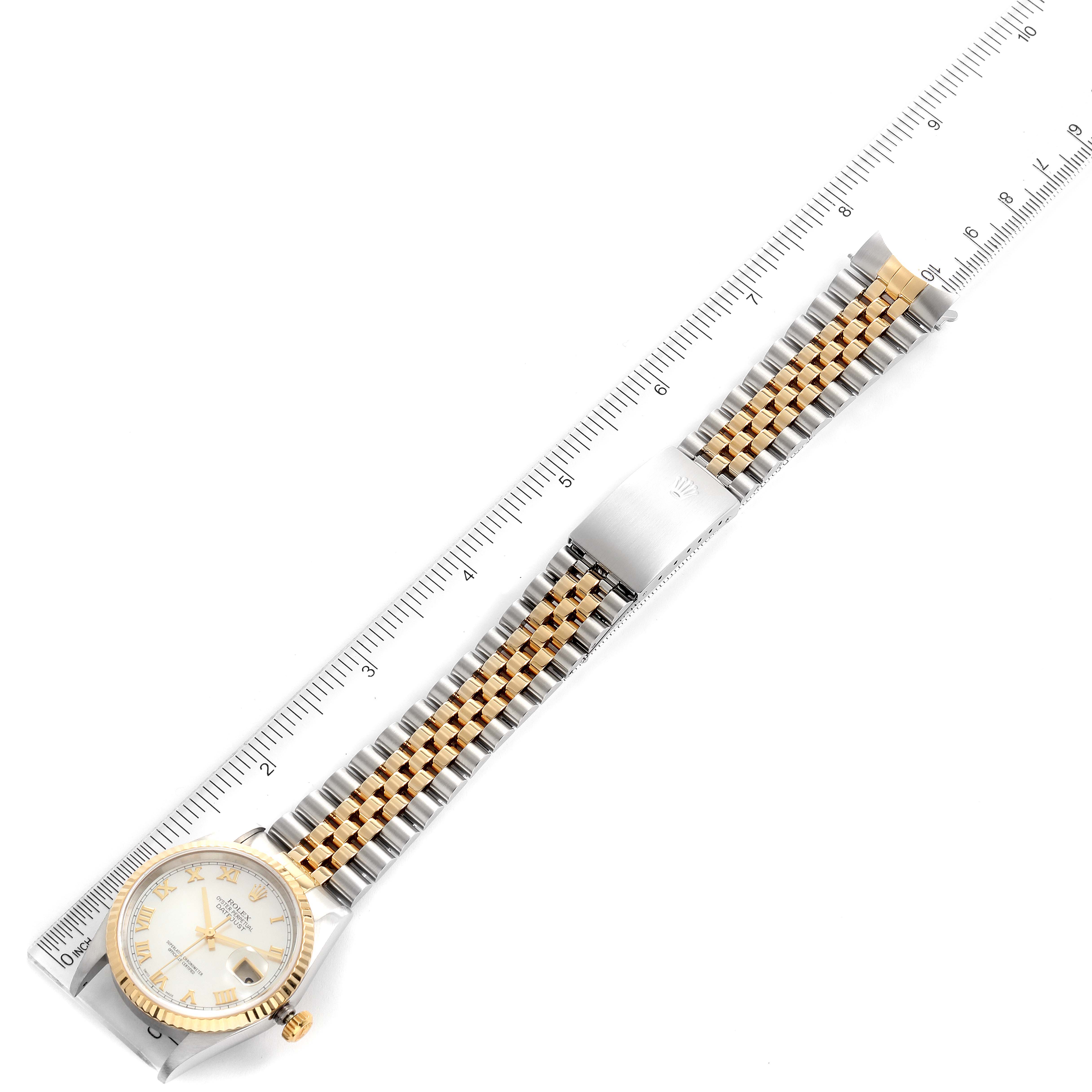 The image shows a top-down view of a Rolex Datejust 16233 Men's Steel and Gold (two tone) Mother of Pearl Dial 16233 Men's Steel and Gold (two tone) Mother of Pearl Dial watch model with its dial, bracelet, and clasp adjacent to a ruler.