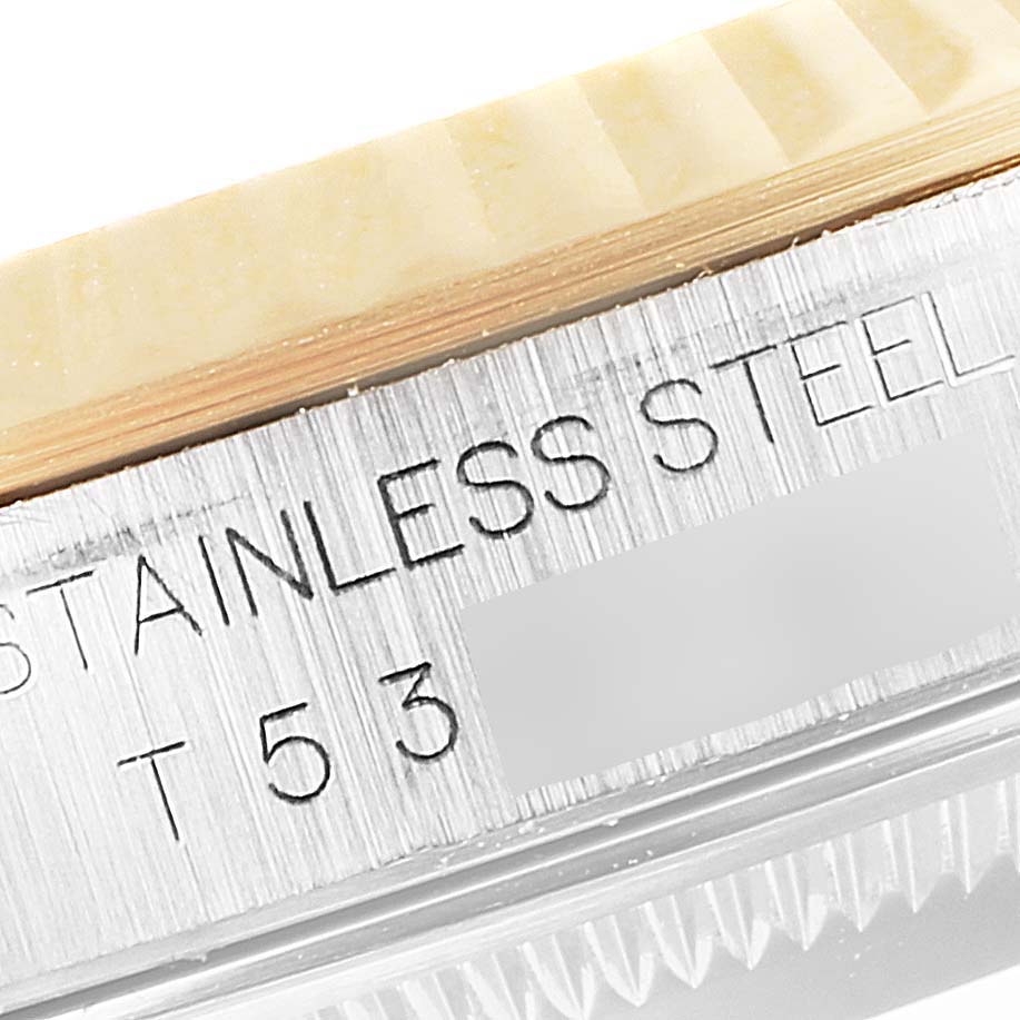 This image shows a close-up view of the side of a Rolex Datejust 16233 Men's Steel and Gold (two tone) Mother of Pearl Dial 16233 Men's Steel and Gold (two tone) Mother of Pearl Dial watch, highlighting the inscription "STAINLESS STEEL" and part of the bezel.