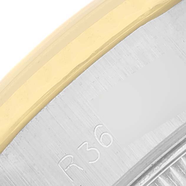 The image shows a close-up of the bezel and part of the case of a Rolex Datejust 69173 Women
s Steel and Gold (two tone) White Dial 69173 Women
s Steel and Gold (two tone) White Dial watch.