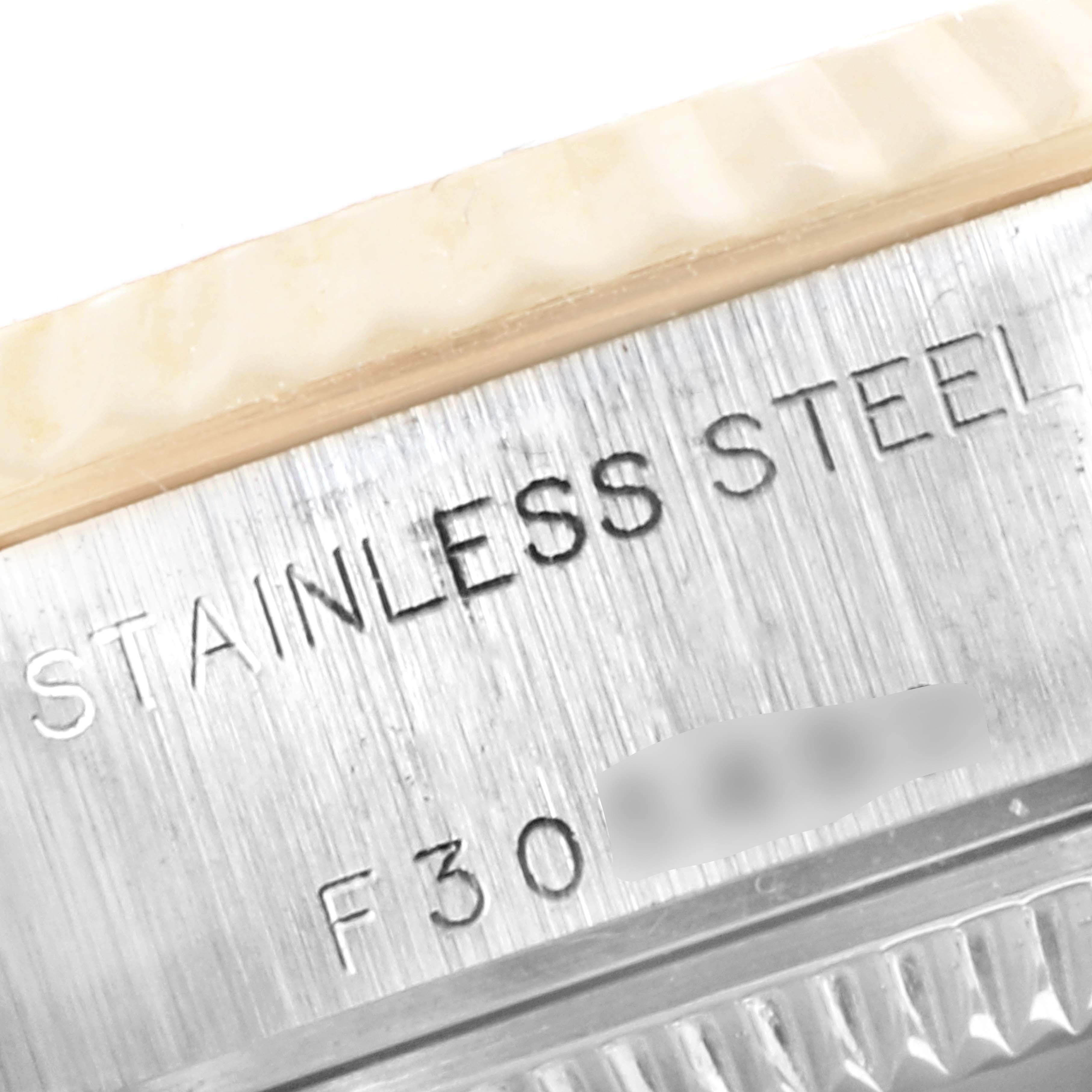 The close-up image shows the side of the Rolex Datejust 79173 Women's Steel and Gold (two tone) White Dial 79173 Women's Steel and Gold (two tone) White Dial, specifically part of the case with "STAINLESS STEEL" engraved.