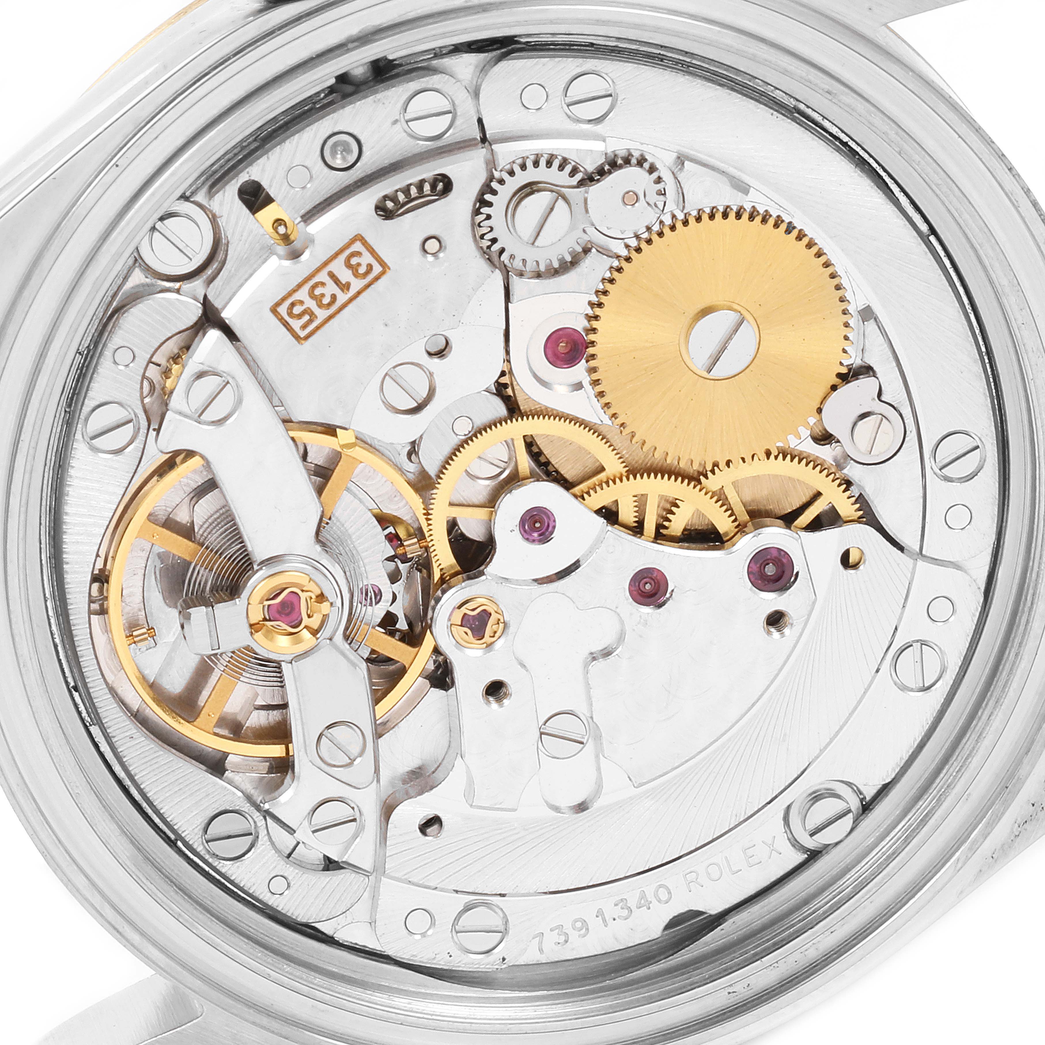 This is an up-close view of the Rolex Datejust 16233 Men's Steel and Gold (two tone) White Dial 16233 Men's Steel and Gold (two tone) White Dial watch's internal movement components, showing gears and mechanisms.