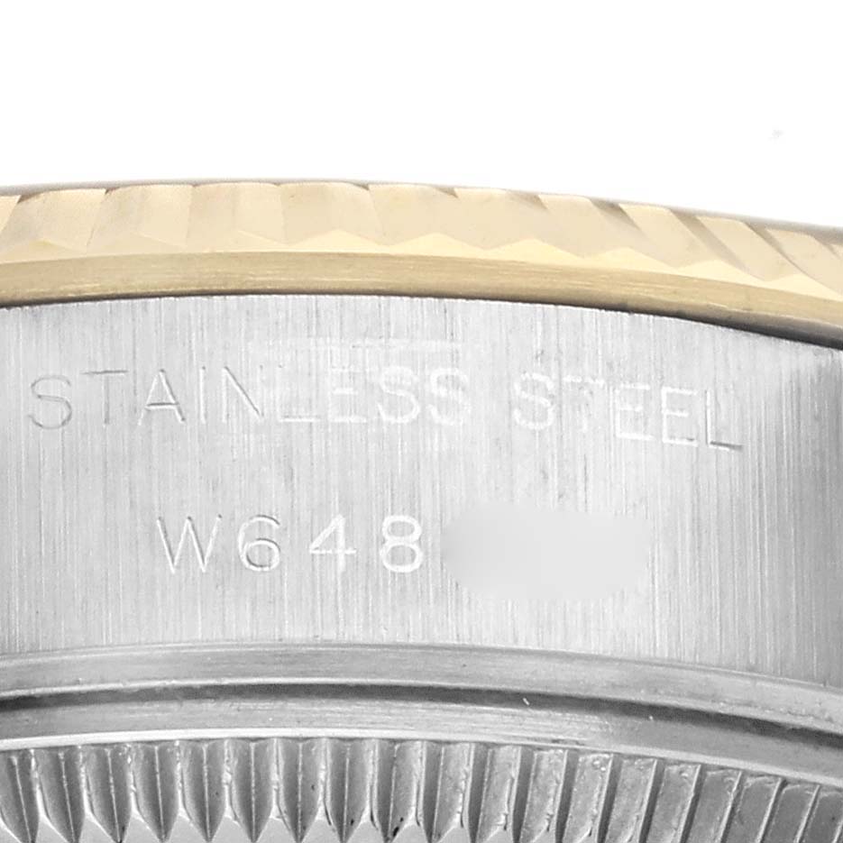 This image shows a close-up of the side and engraving on a Rolex Datejust 69173 Women's Steel and Gold (two tone) Blue Dial 69173 Women's Steel and Gold (two tone) Blue Dial watch, including part of the bezel and case.