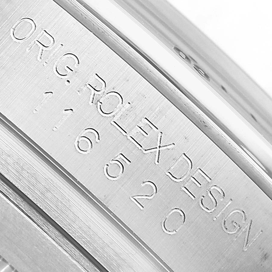 The image shows the engraved side detailing of the Rolex Daytona 116520 Men's Stainless Steel White Dial, highlighting the model and brand.