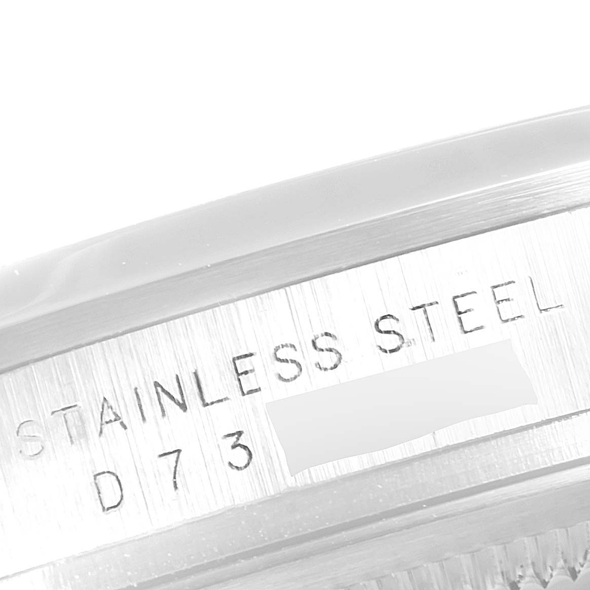 This close-up image shows the stainless steel engraving and part of the bezel of a Rolex Explorer 114270  Men
s Stainless Steel Black Dial 114270  Men
s Stainless Steel Black Dial watch.