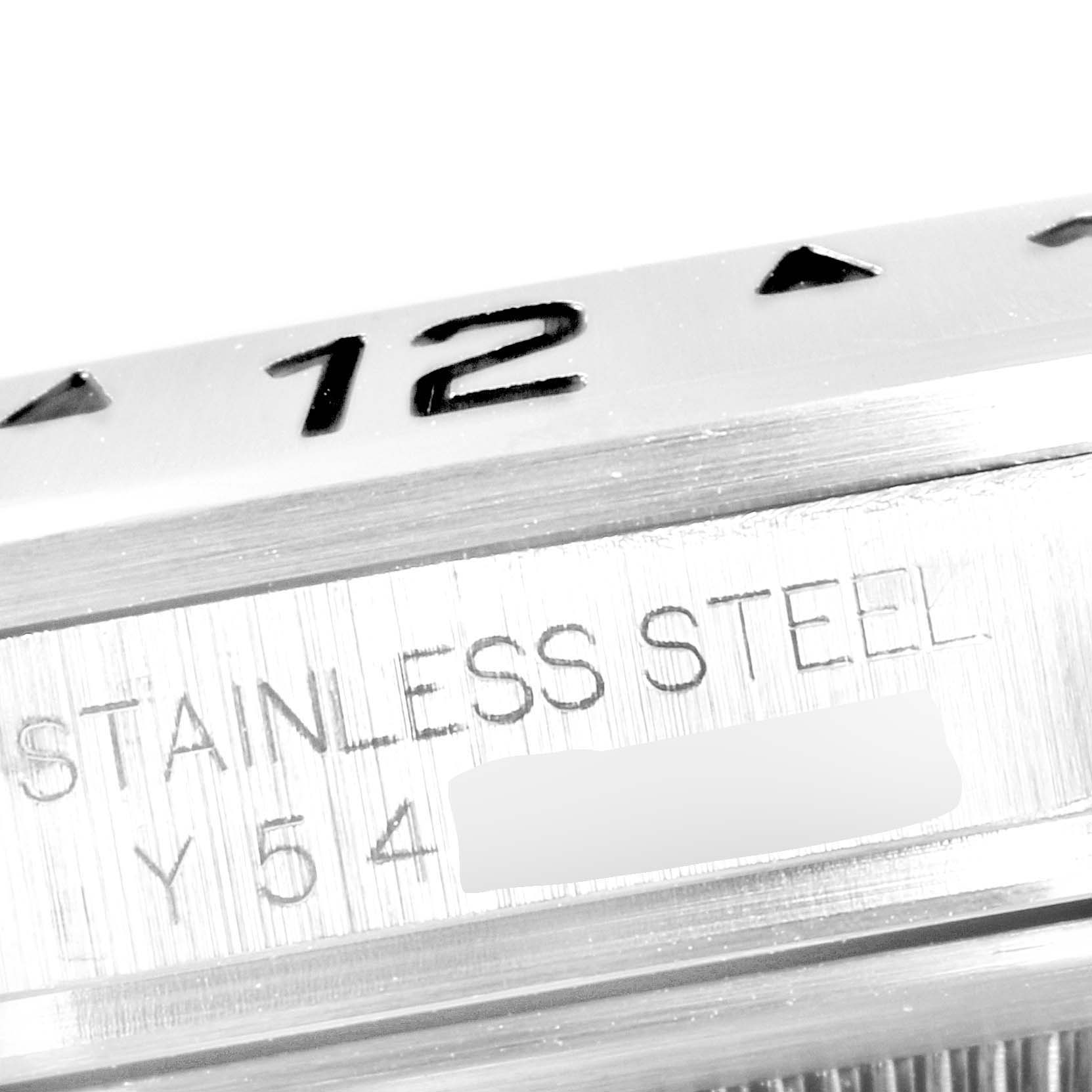 The image shows a macro view of the bezel and serial number engraving on the side of a Rolex Explorer 16570 Men
s Stainless Steel Black Dial 16570 Men
s Stainless Steel Black Dial watch, highlighting "STAINLESS STEEL" text.