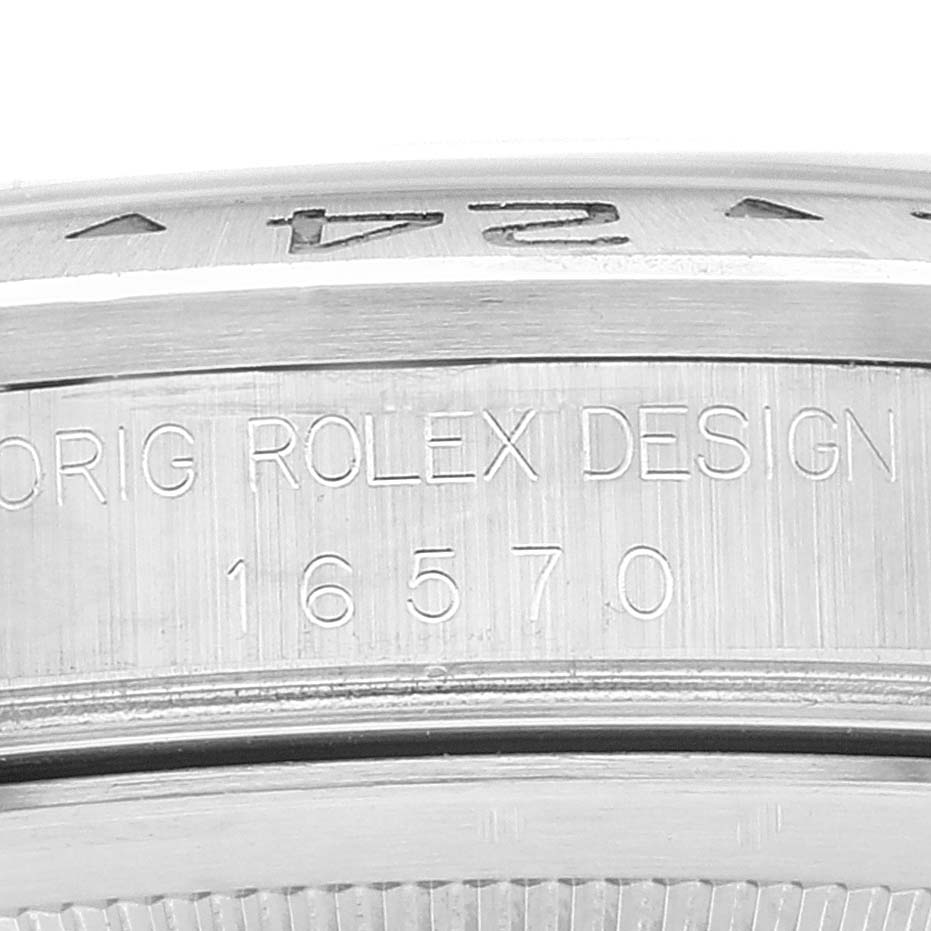 This close-up shows the engraved model number and "ORIG ROLEX DESIGN" on the case of a Rolex Explorer 16570 Men's Stainless Steel Black Dial 16570 Men's Stainless Steel Black Dial watch.