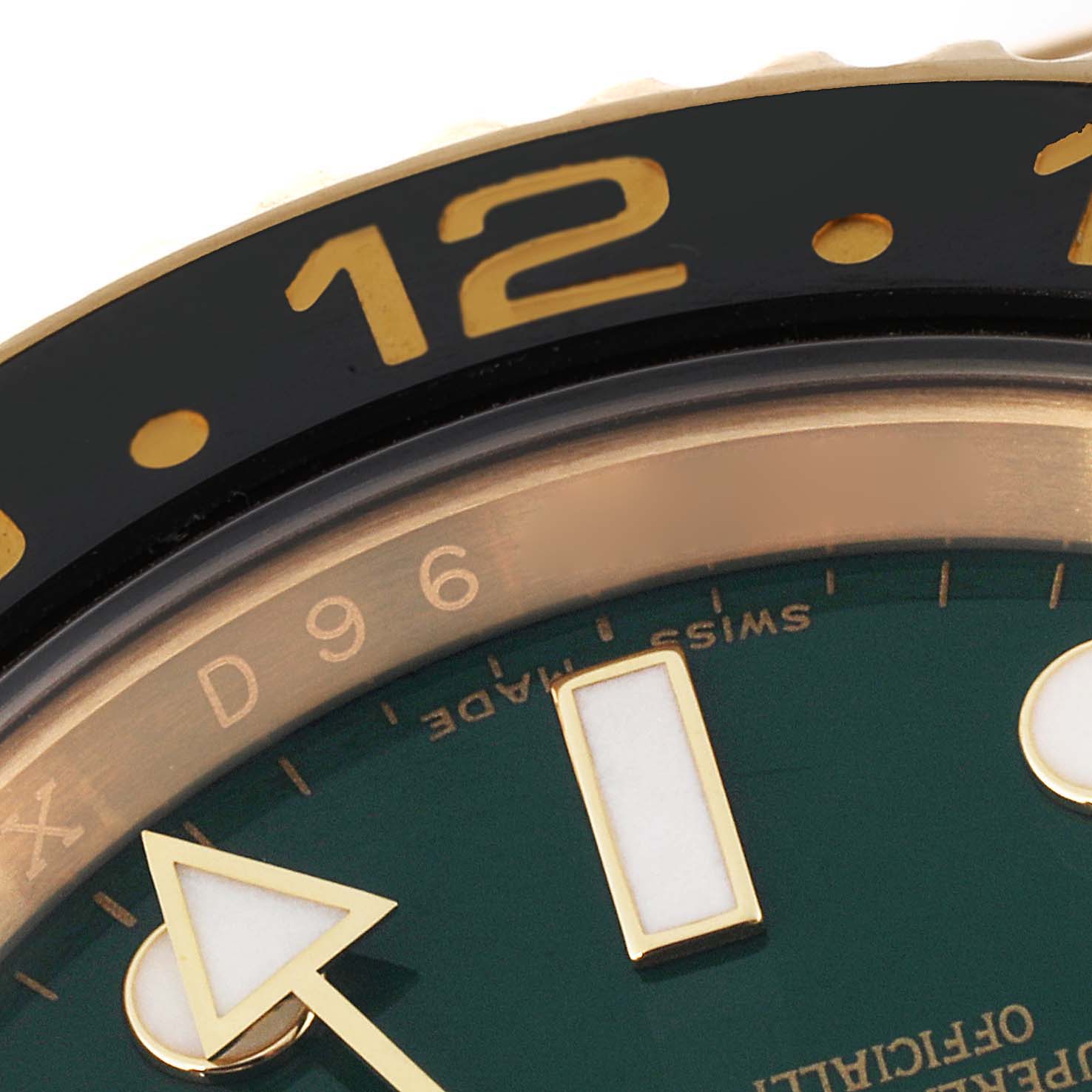 This close-up image of the Rolex GMT-Master 116718 Men's Yellow Gold Green Dial 116718 Men's Yellow Gold Green Dial watch shows the bezel, part of the dial, and the GMT hand.