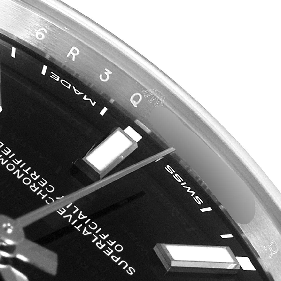 The image shows a close-up of the dial and hour markers of a Rolex Oyster Perpetual 114300 Men's Stainless Steel Black Dial 114300 Men's Stainless Steel Black Dial watch, focusing on the top-right portion of the face.
