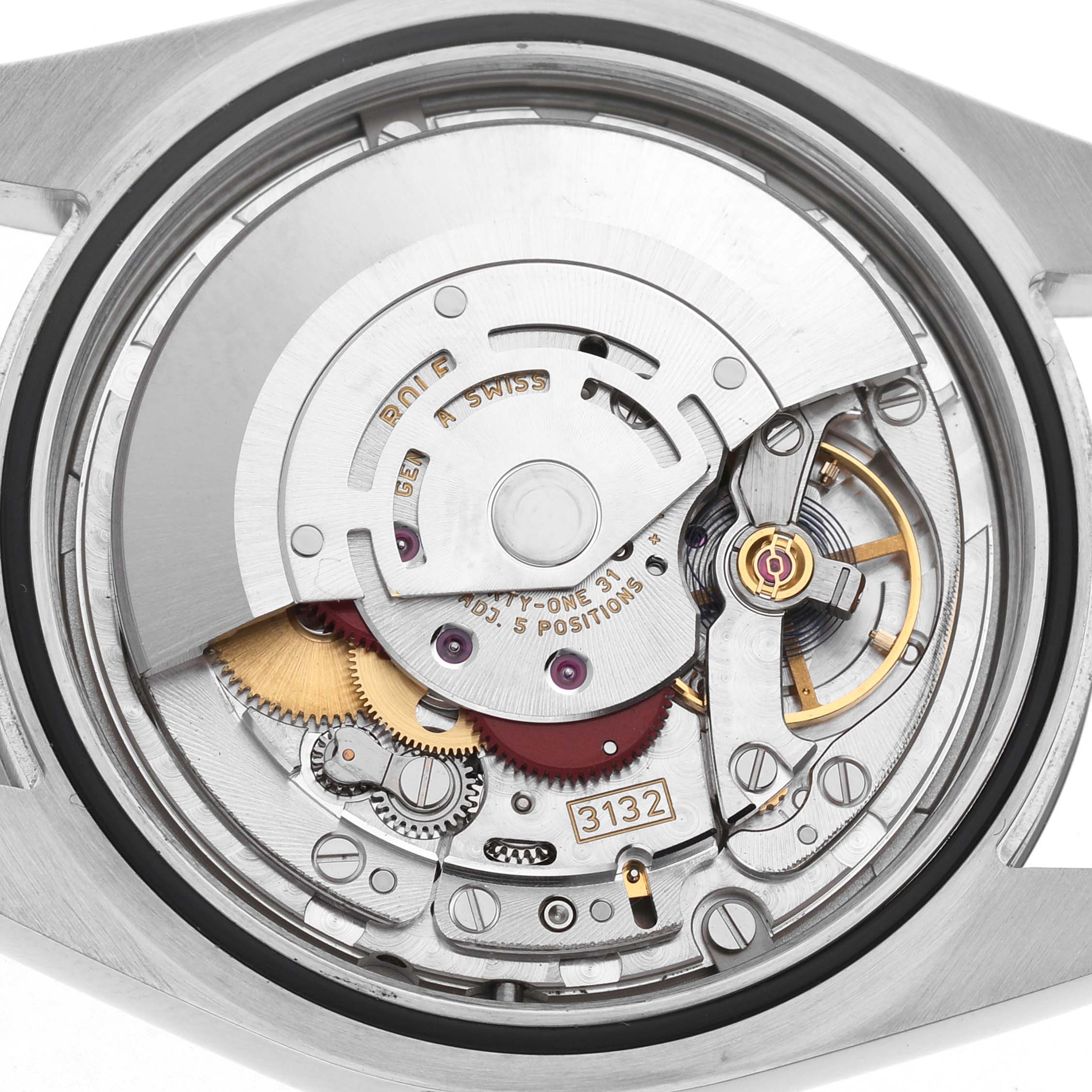 The image shows the movement of the Rolex Oyster Perpetual 114300 Men's Stainless Steel Grey Dial watch from a back angle, highlighting gears and mechanisms.